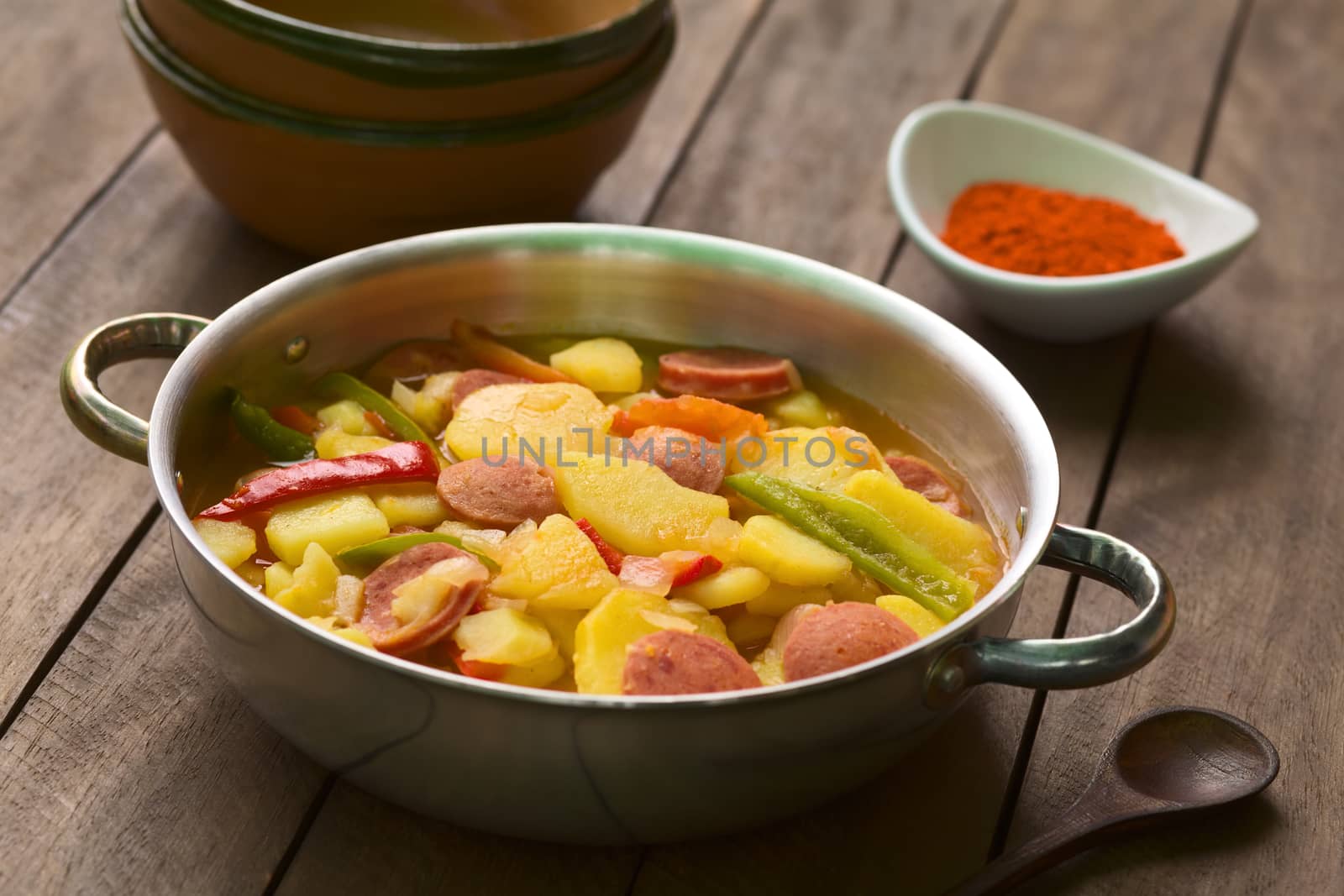 Hungarian dish called Paprikas Krumpli (Potato with Paprika), a stew made of potato, onion, pepper, tomato and sausage, seasoned with the Hungarian paprika and salt (Selective Focus, Focus in the middle of the dish) 