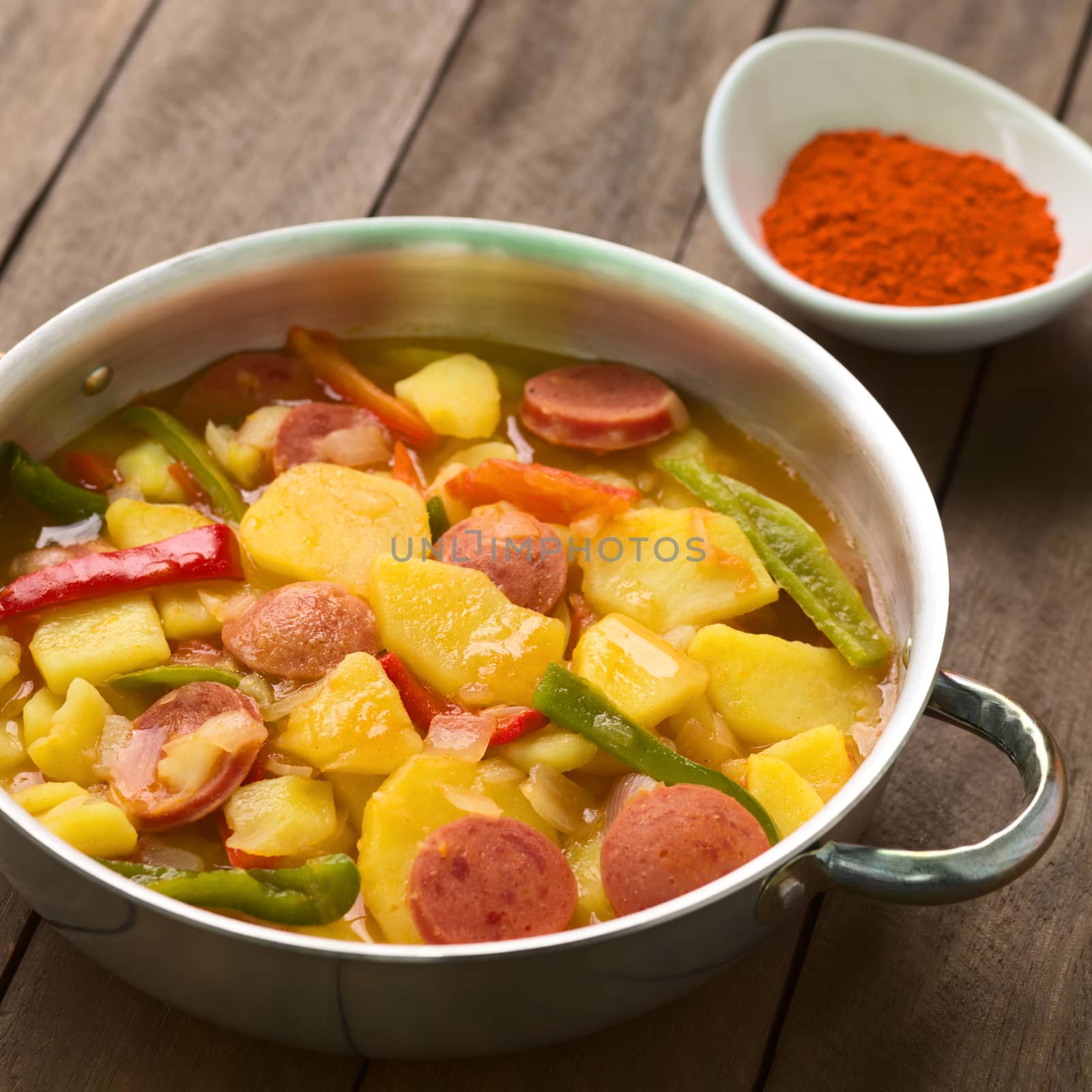 Hungarian dish called Paprikas Krumpli (Potato with Paprika), a stew made of potato, onion, pepper, tomato and sausage, seasoned with the Hungarian paprika and salt (Selective Focus, Focus in the middle of the dish) 