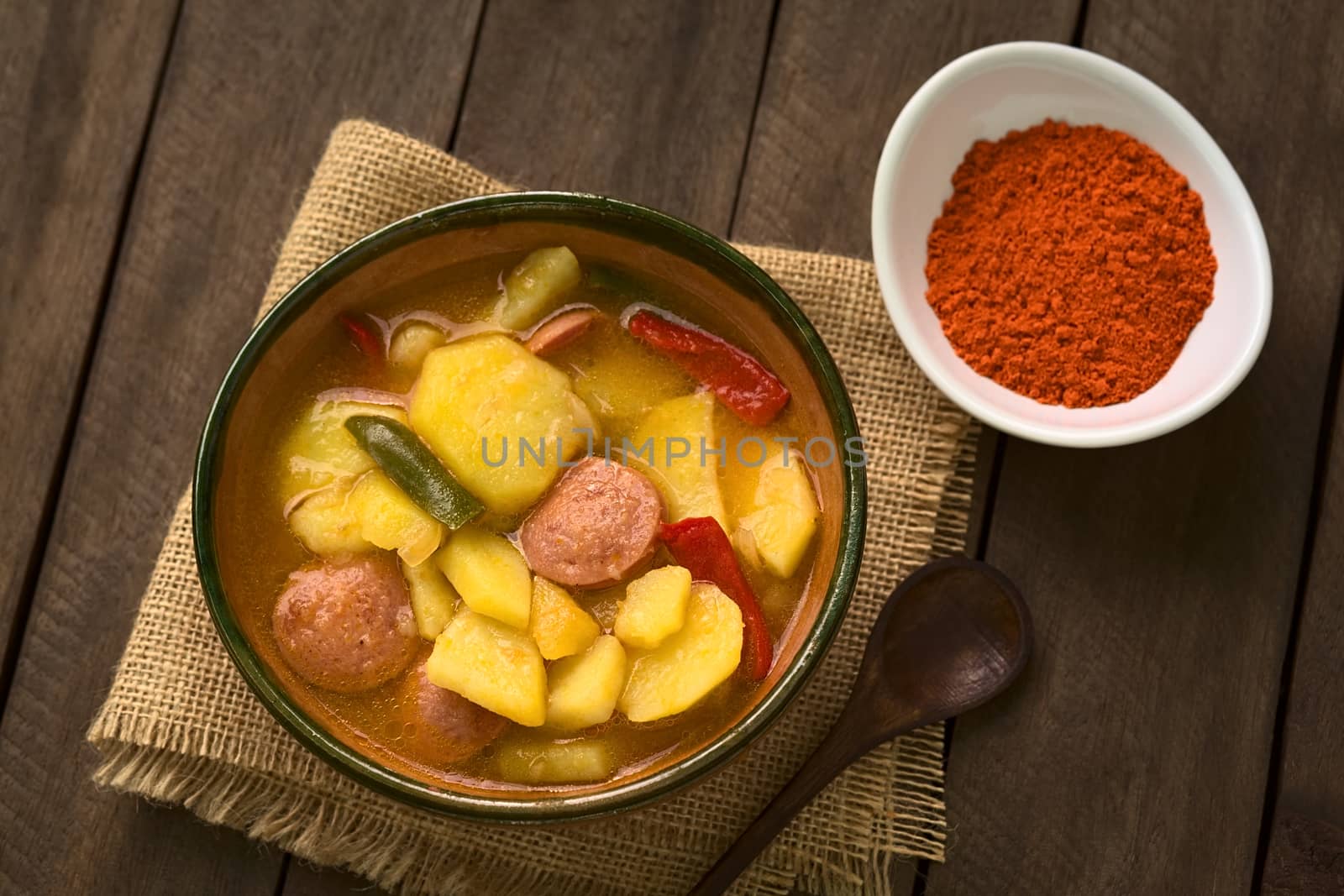 A bowl of the Hungarian dish called Paprikas Krumpli (Potato with Paprika), a stew made of potato, onion, pepper, tomato and sausage, seasoned with the Hungarian paprika and salt (Selective Focus, Focus in the middle of the dish) 