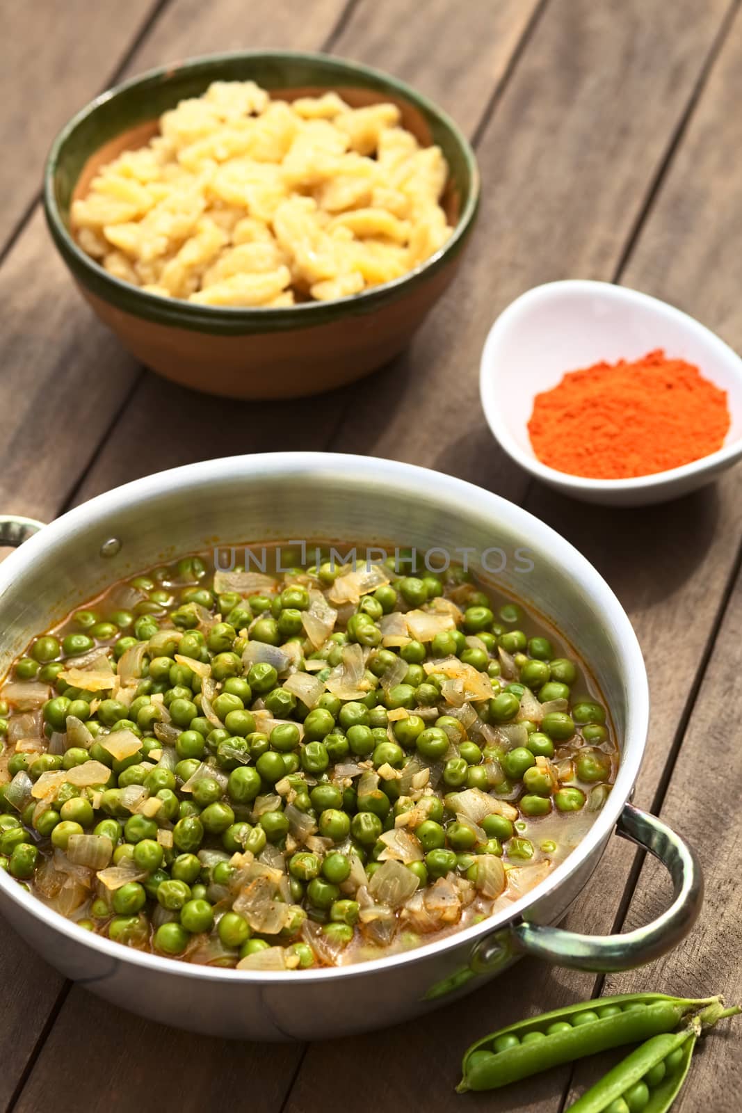 Hungarian pea stew made of onion and peas and seasoned with paprika and salt, served usually with Hungarian galuska or nokedli (homemade noodles) (Selective Focus, Focus into the middle of the stew)