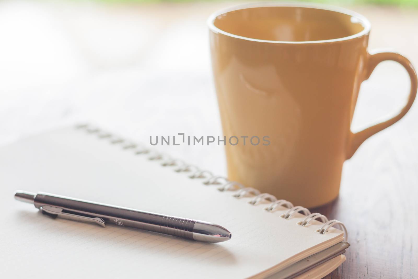 Pen and notebook with coffee mug, stock photo