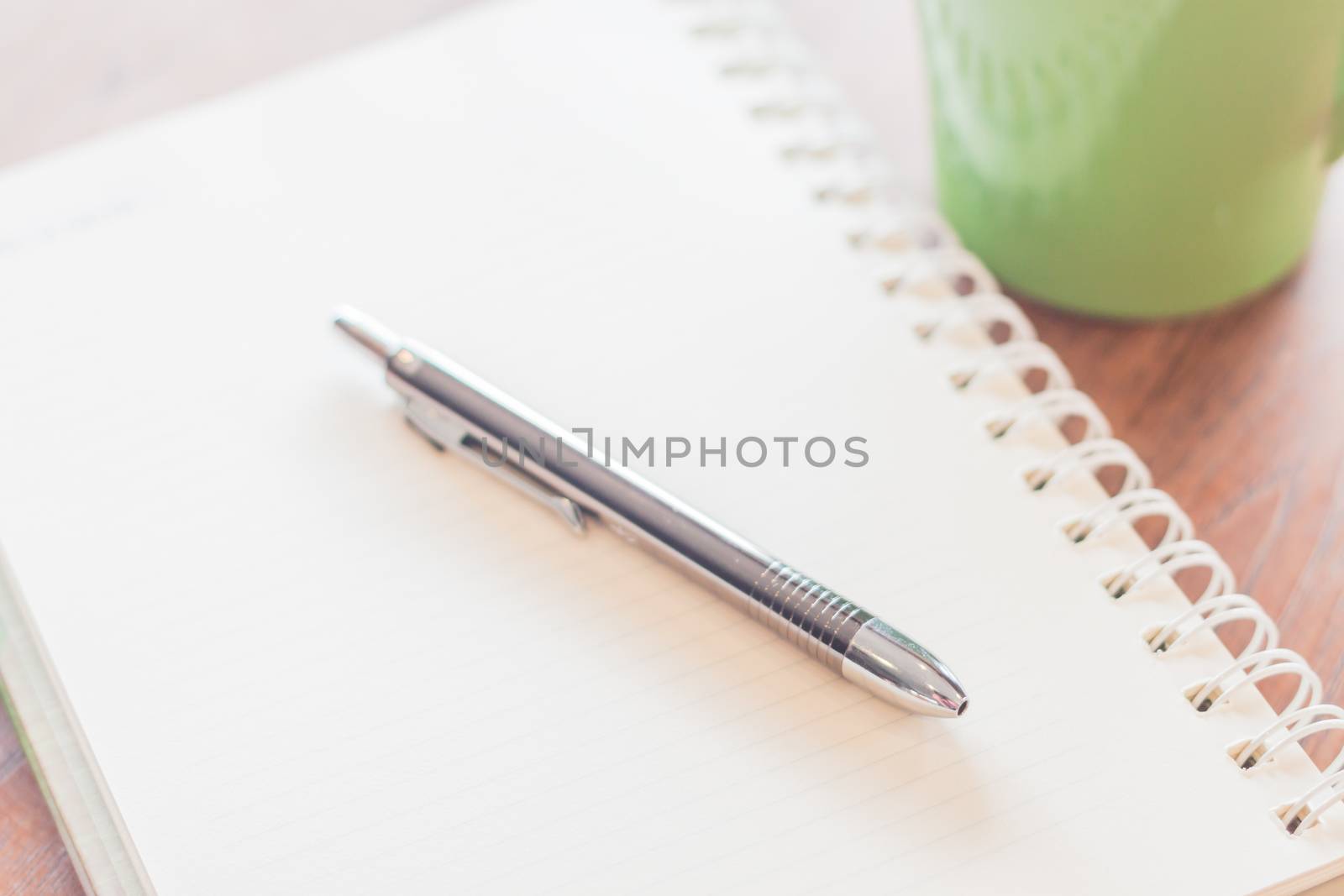 Closeup pen and spiral notebook by punsayaporn