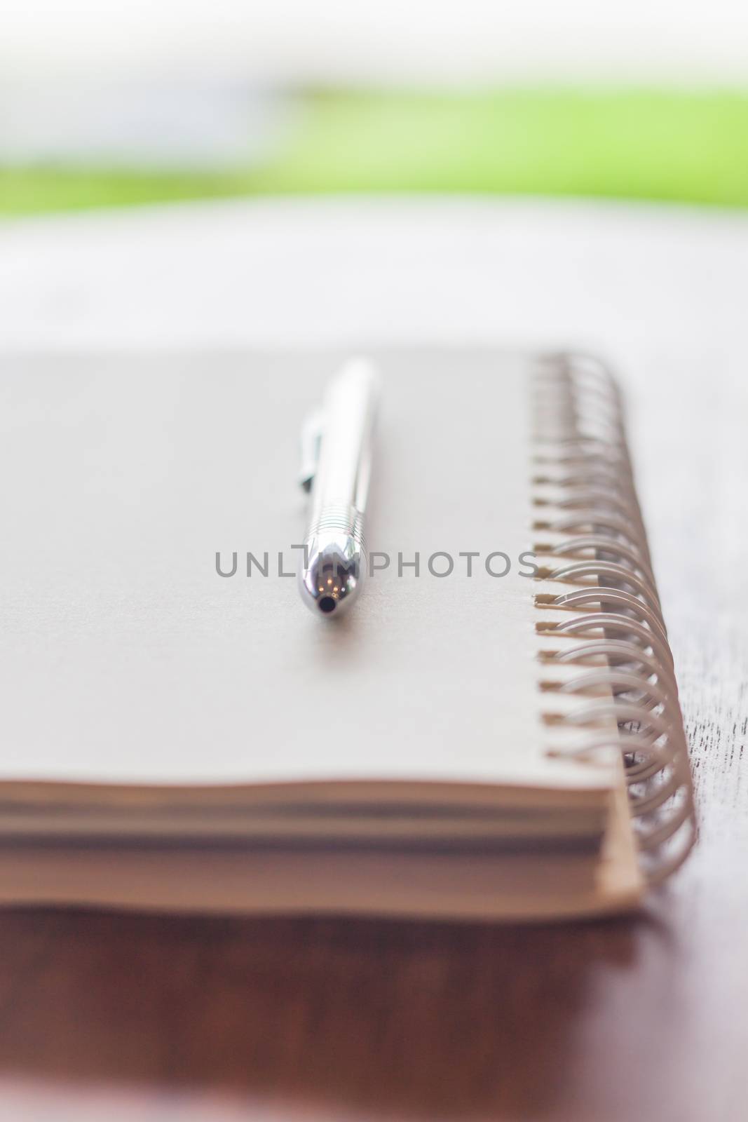 Spiral notebook with pen by punsayaporn