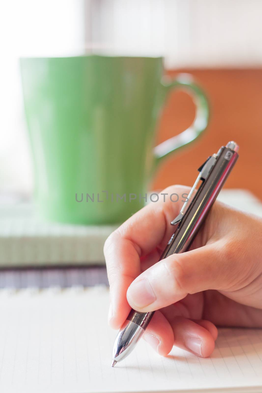 Hand writing on notebook in coffee shop