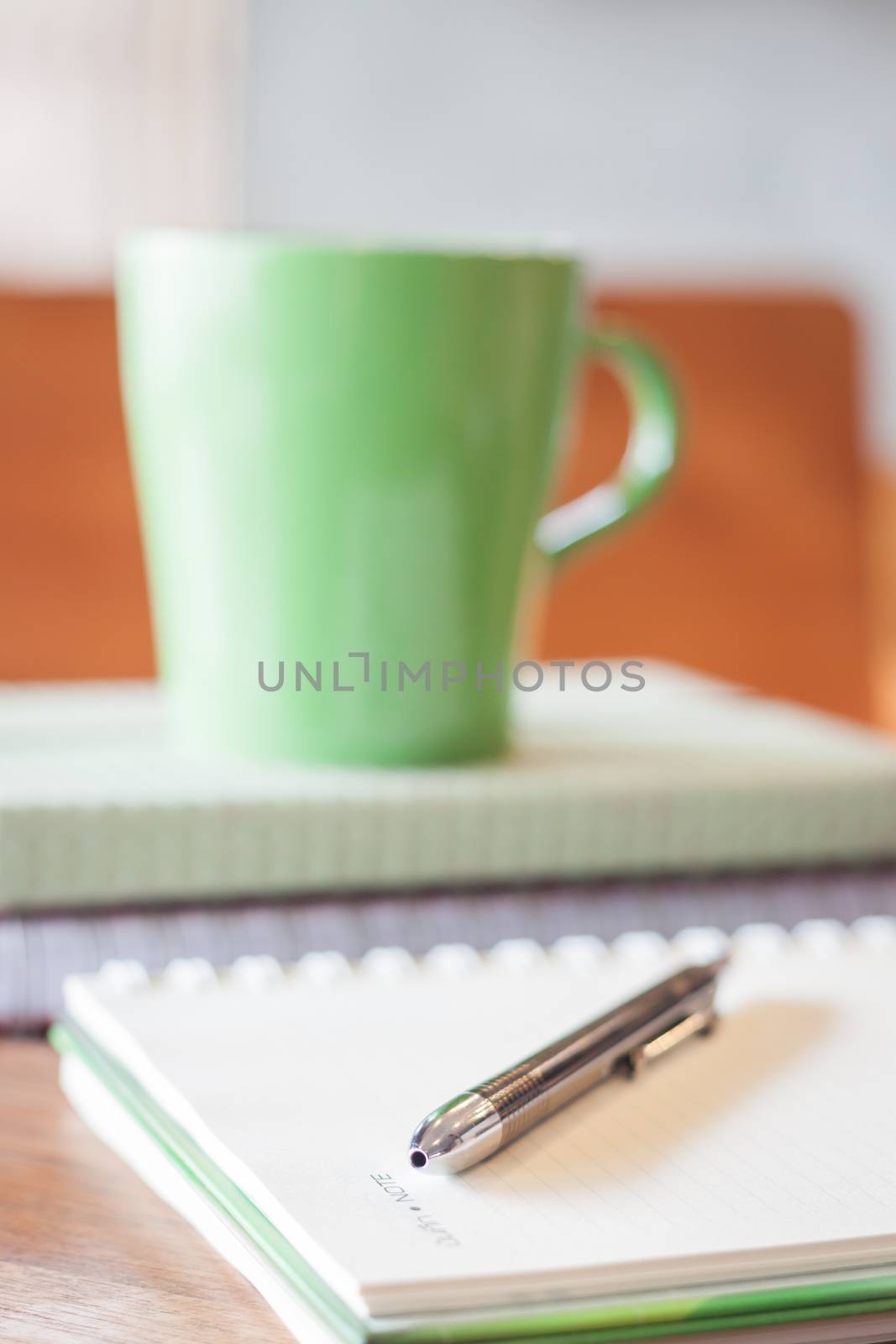 Closeup pen on green mug background by punsayaporn