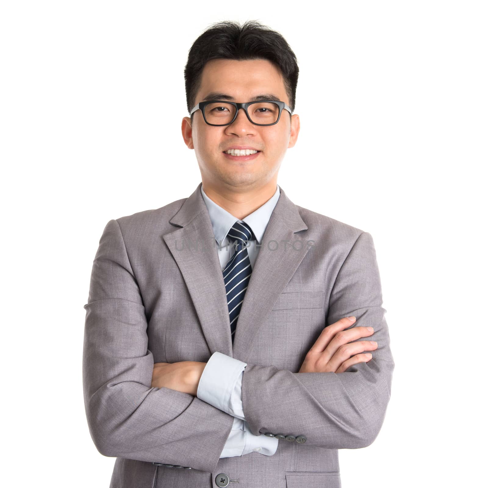 Portrait of Asian business man arms folded smiling, standing isolated on white background.