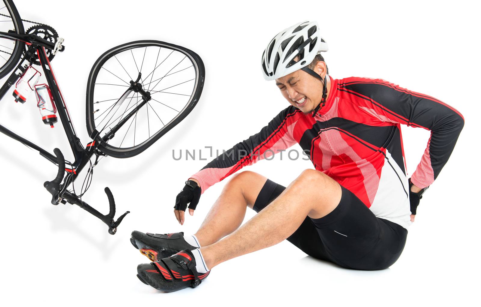 Asian biker fell down from bike, injured at back with painful facial expression, sitting on floor, isolated on white background.