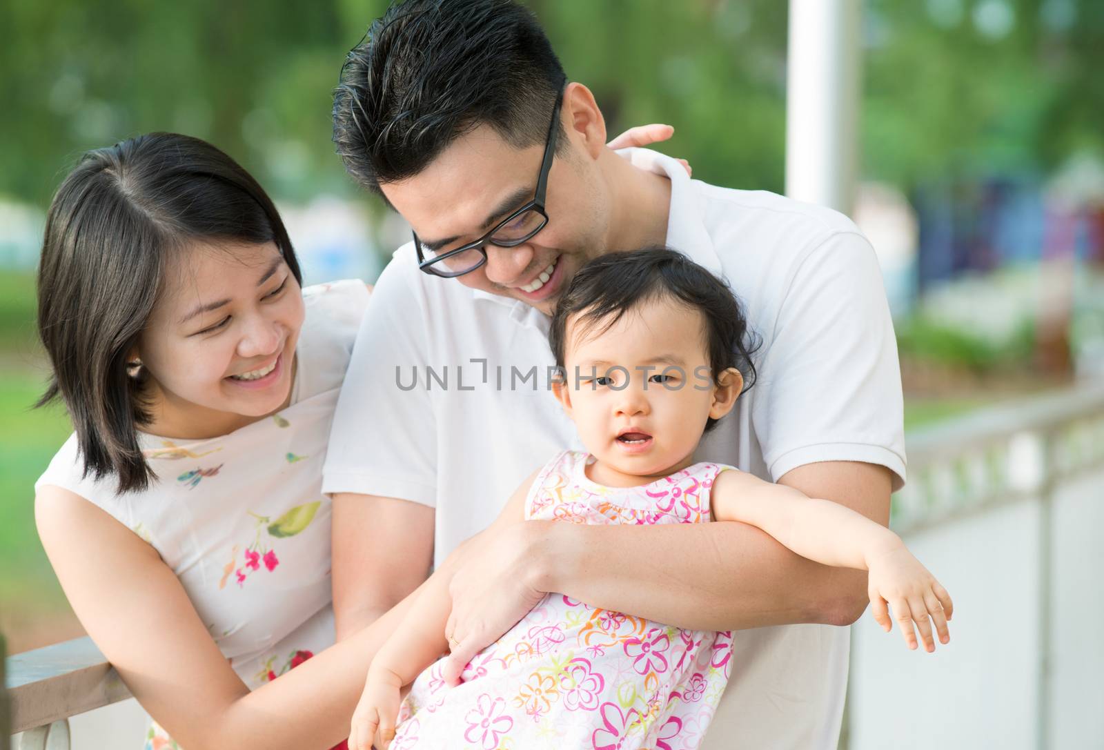 Happy Asian Family enjoying family time together in the park