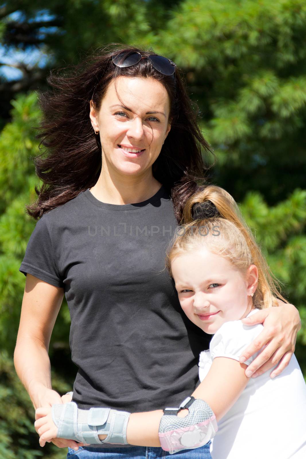 Photo of smiling mother and daughter in summer