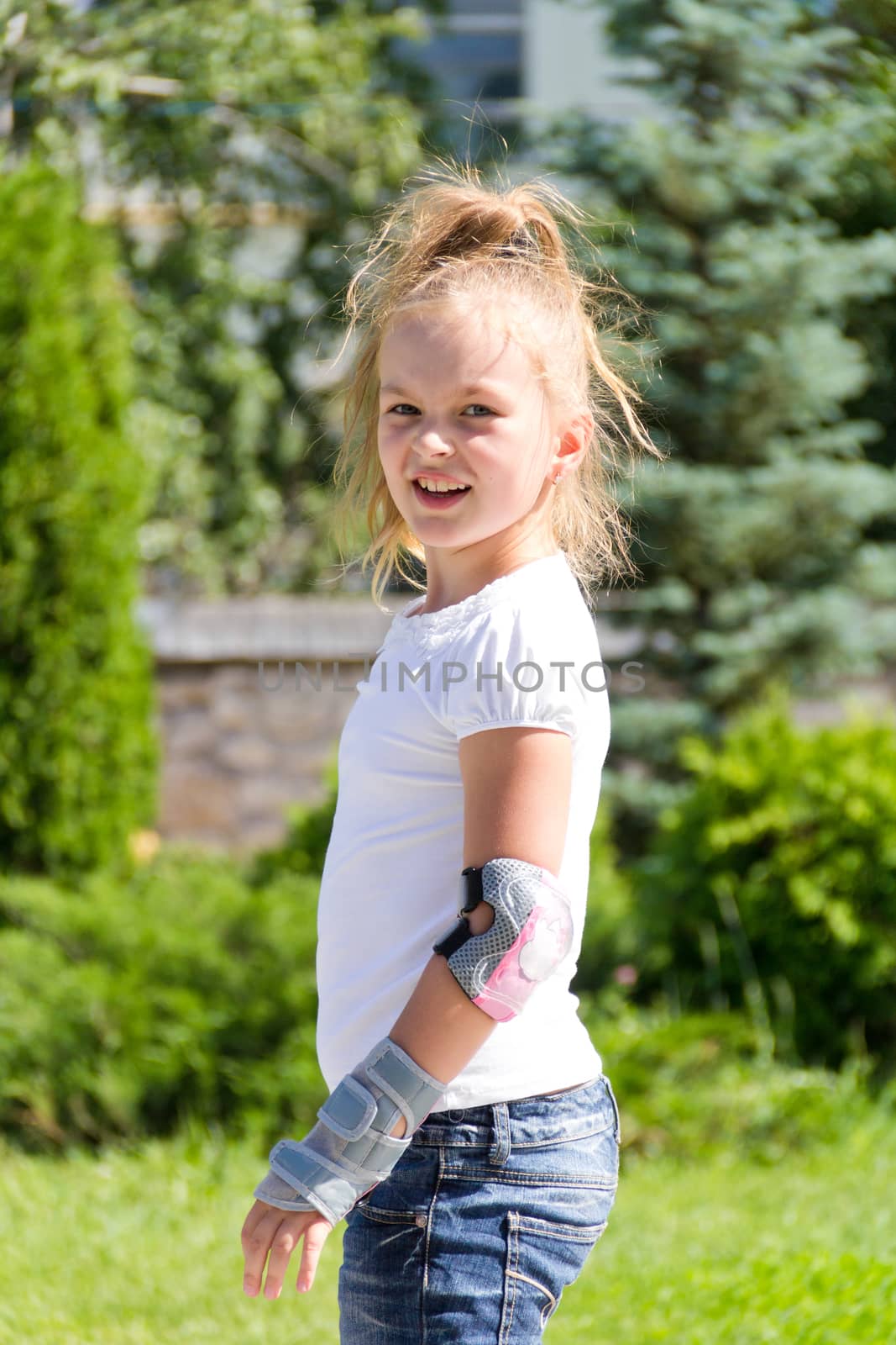 Photo of cute girl on roller skates in summer