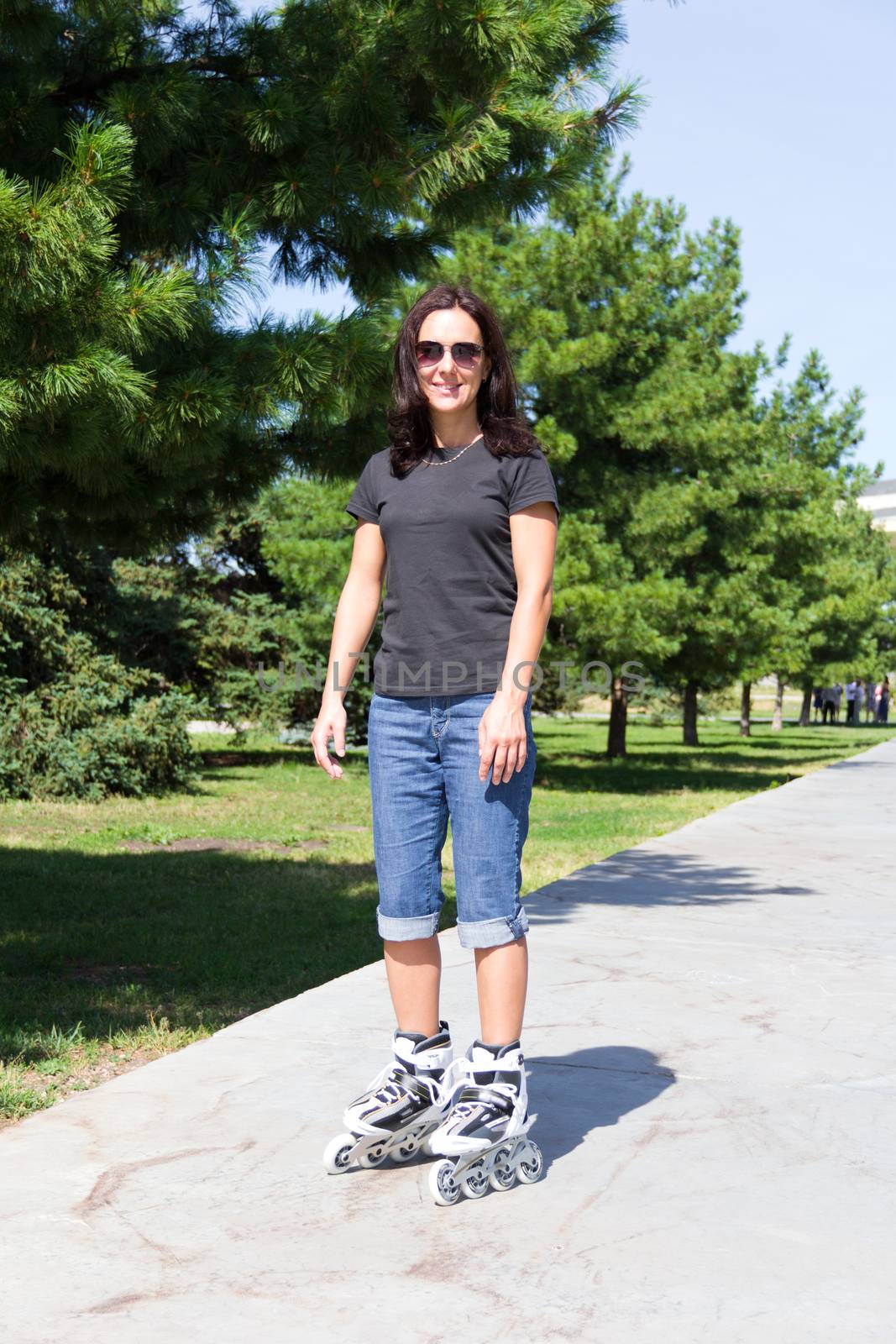 Young woman on roller skates in summer