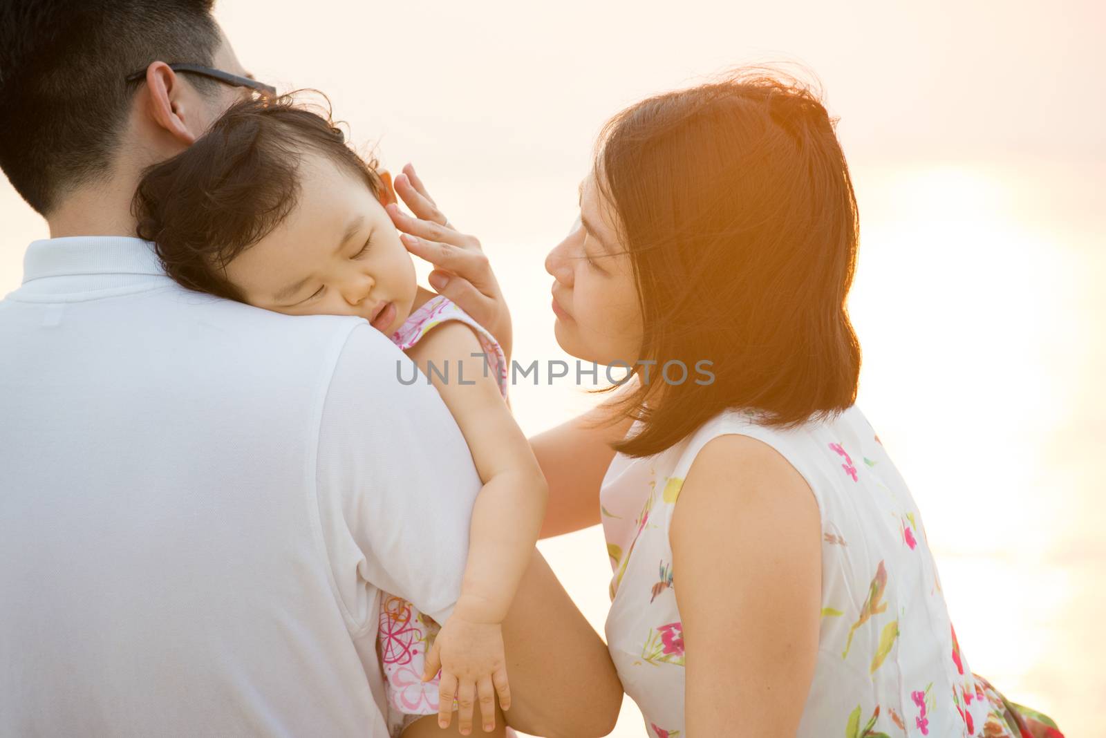 Young Asian family at outdoor beach by szefei