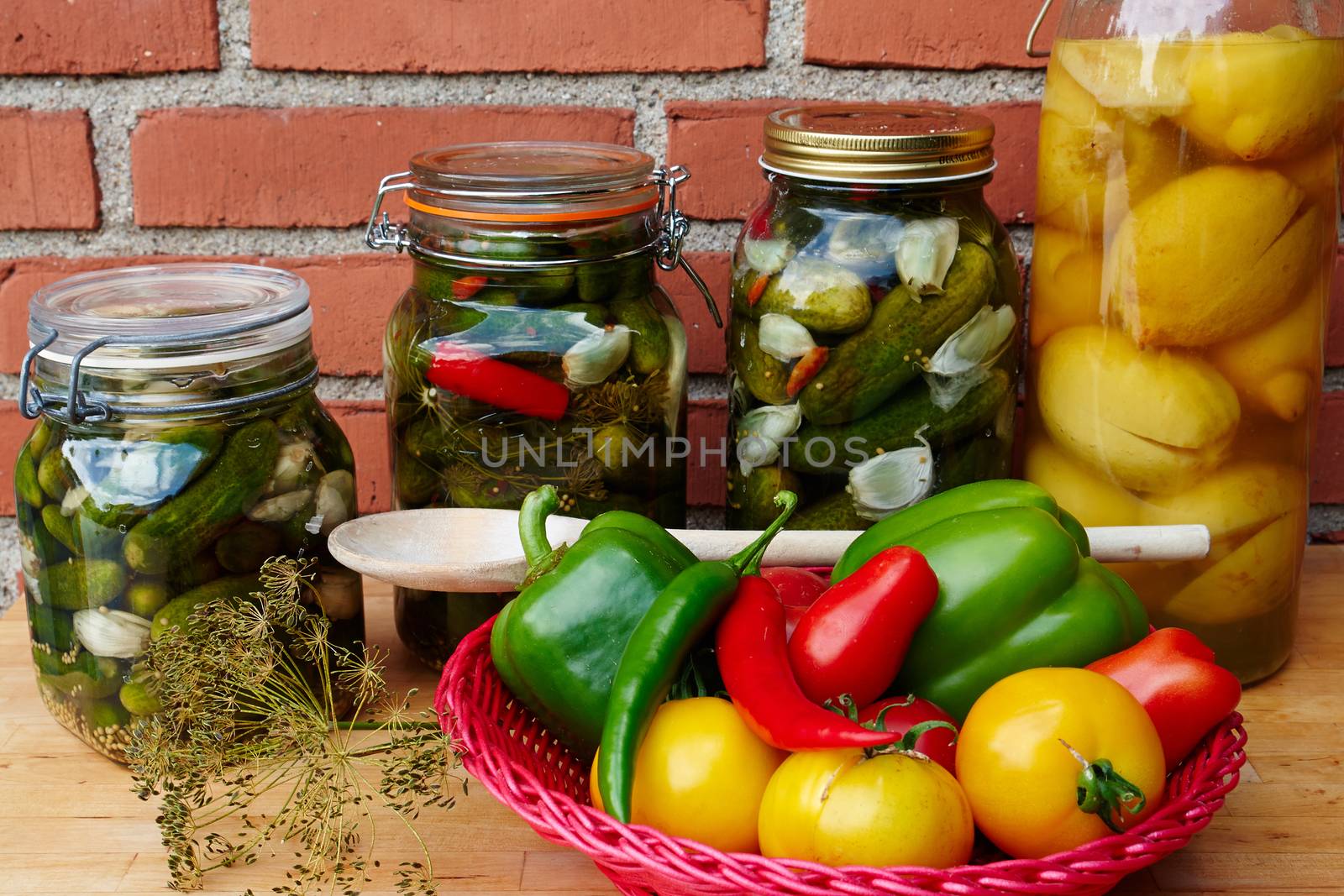 Fresh homemade pickles cucumbers and lemons in glass gars