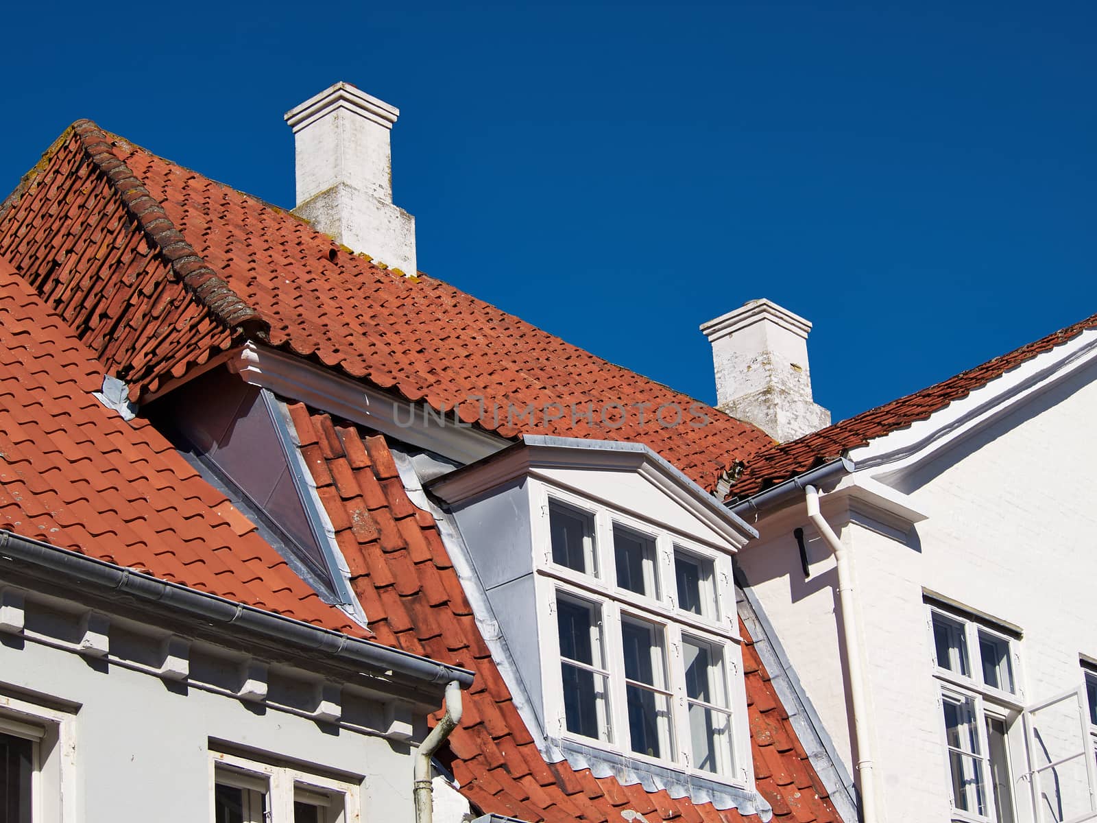 White traditional Danish houses with blue sky background Denmark