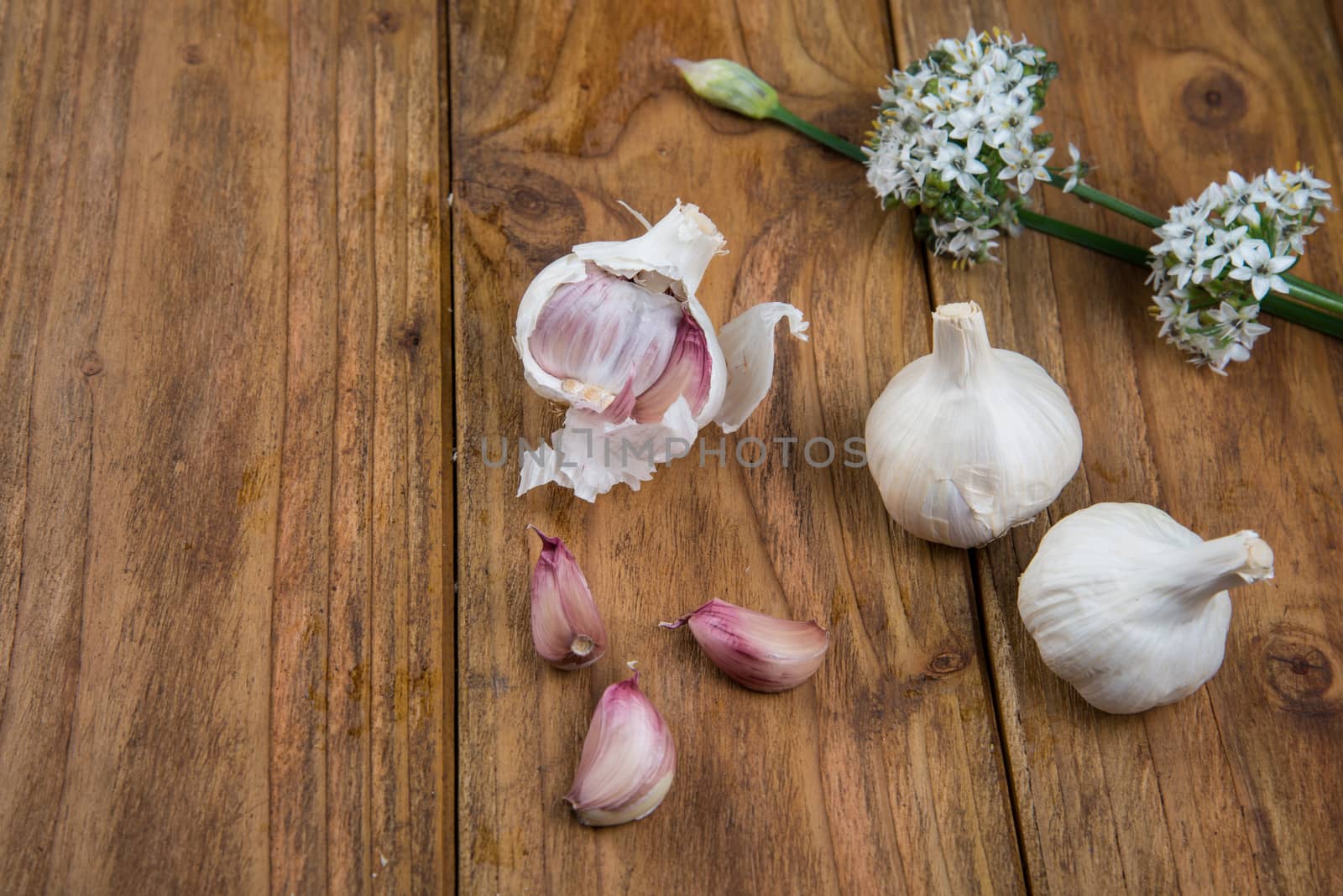 Fresh garlic bulb and flowers and naan bread on kitchen table