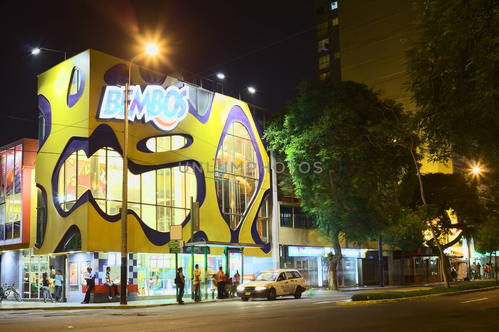 LIMA, PERU - MARCH 12, 2012: The Peruvian fast food restaurant Bembos on the corner of Avenida Jose Larco and Calle Jose Gonzales in the district of Miraflores in th evening of March 12, 2012 in Lima, Peru. Bembos offers a variety of hamburgers with Peruvian flavors and other fast food snacks.