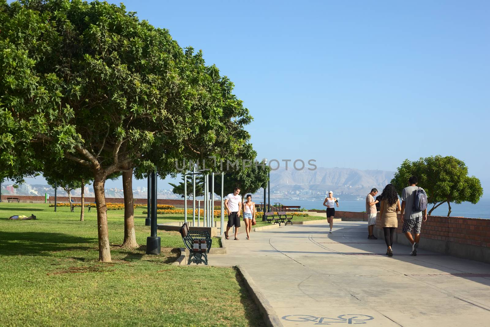 LIMA, PERU - MARCH 30, 2012: Unidentified people in Antonio Raimondi Park on the coast of the district of Miraflores with view onto the southern coastline of Lima in the back on March 30, 2012 in Lima, Peru. This coastal park is very popular for leisure and sport.