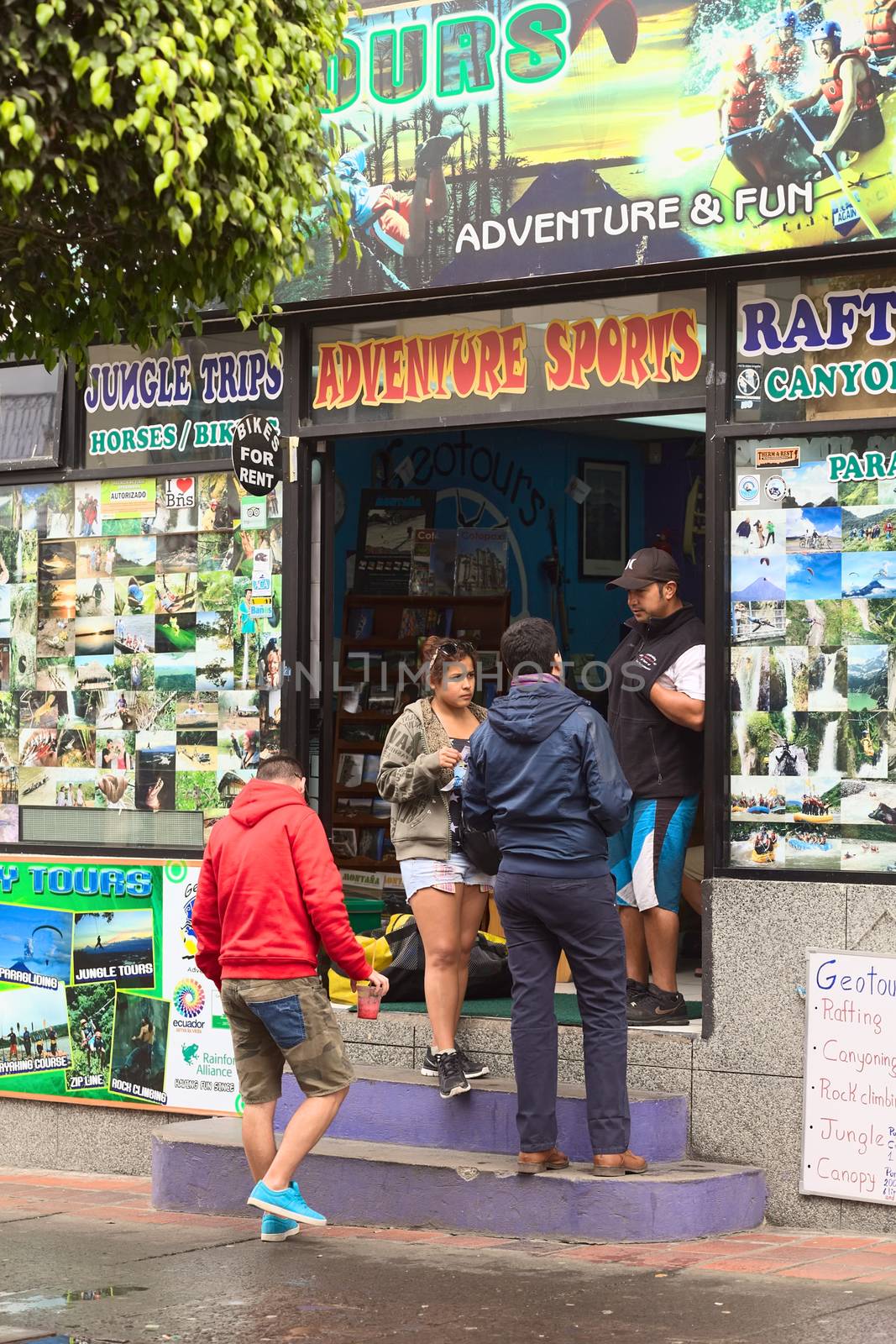 BANOS, ECUADOR - FEBRUARY 25, 2014: Unidentified people at Geotours travel agency and tour operator on Ambato Street on February 25, 2014 in Banos, Ecuador. Banos is a small touristy town, which is known for its various outdoor activities and where numerous travel agencies and tour operators can be found. 