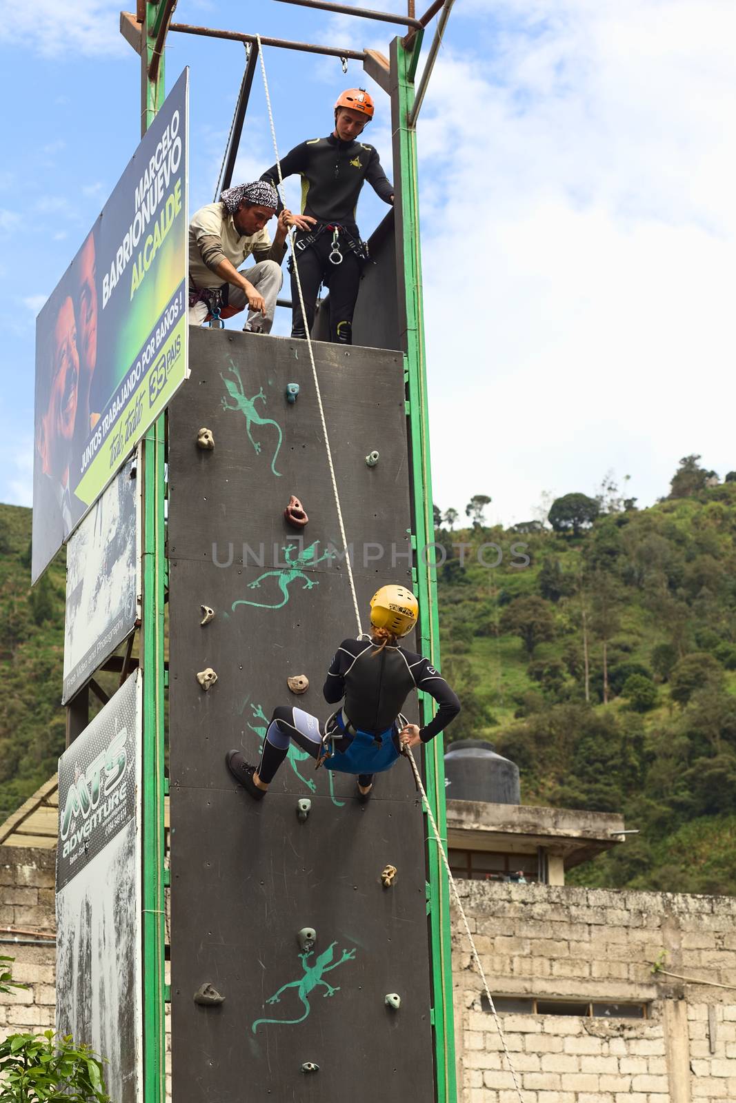 BANOS, ECUADOR - FEBRUARY 25, 2014: Unidentified person practicing abseiling for canyoning on a climbing wall on February 25, 2014 in Banos, Ecuador. Banos is a small touristy town offering a lot of outdoor activities, such as canyoning (abseiling a waterfall).