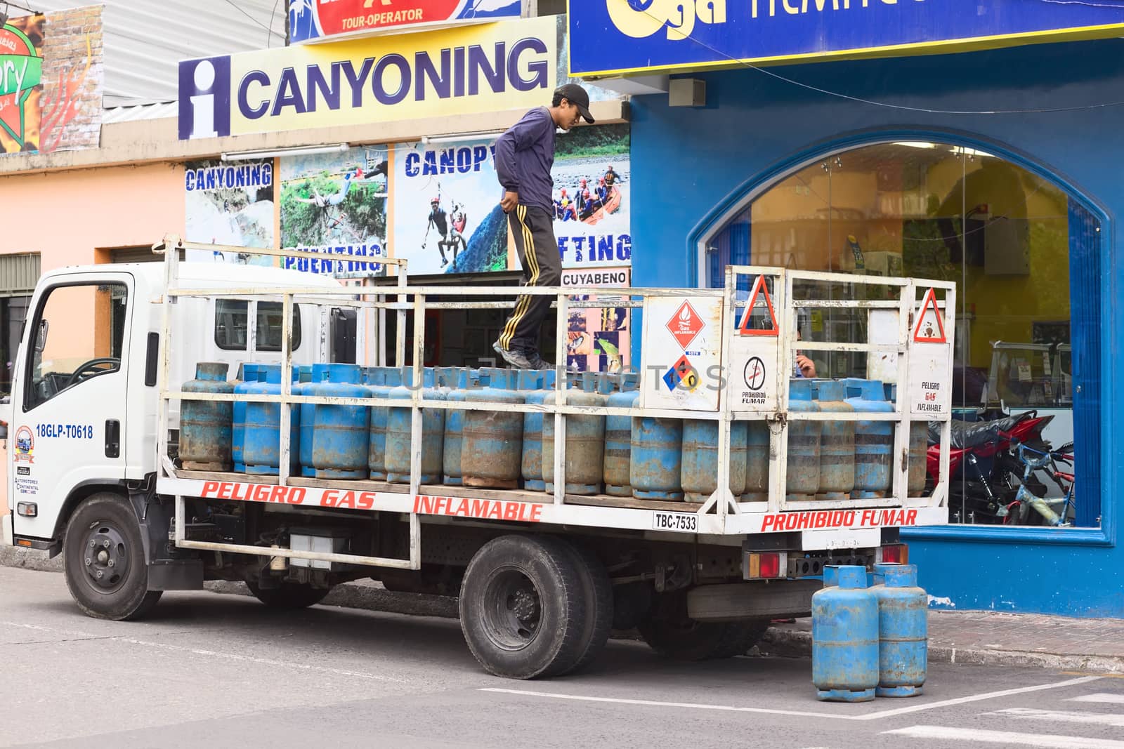 Man on Truck with Gas Bottles in Banos, Ecuador by ildi