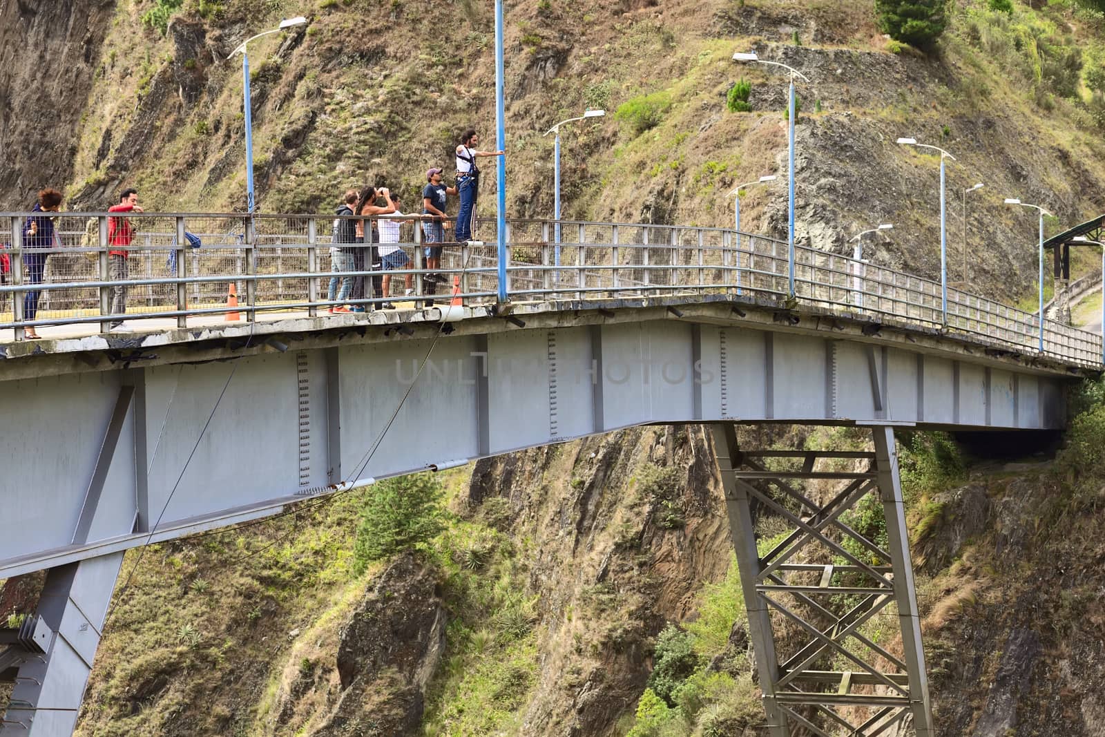 BANOS, ECUADOR - FEBRUARY 26, 2014: Unidentified people at bridge jumping (puenting) on San Francisco Bridge on February 26, 2014 in Banos, Ecuador. Banos is popular for its outdoor activities such as bridge jumping. The jump from this bridge is 45 meters into the canyon of the Pastaza River. 