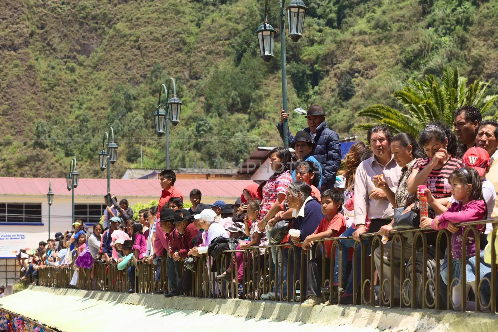 BANOS, ECUADOR - MARCH 2, 2014: Unidentified people watching the carnival parade on Ambato Street at Sebastian Acosta Park on March 2, 2014 in Banos, Ecuador.