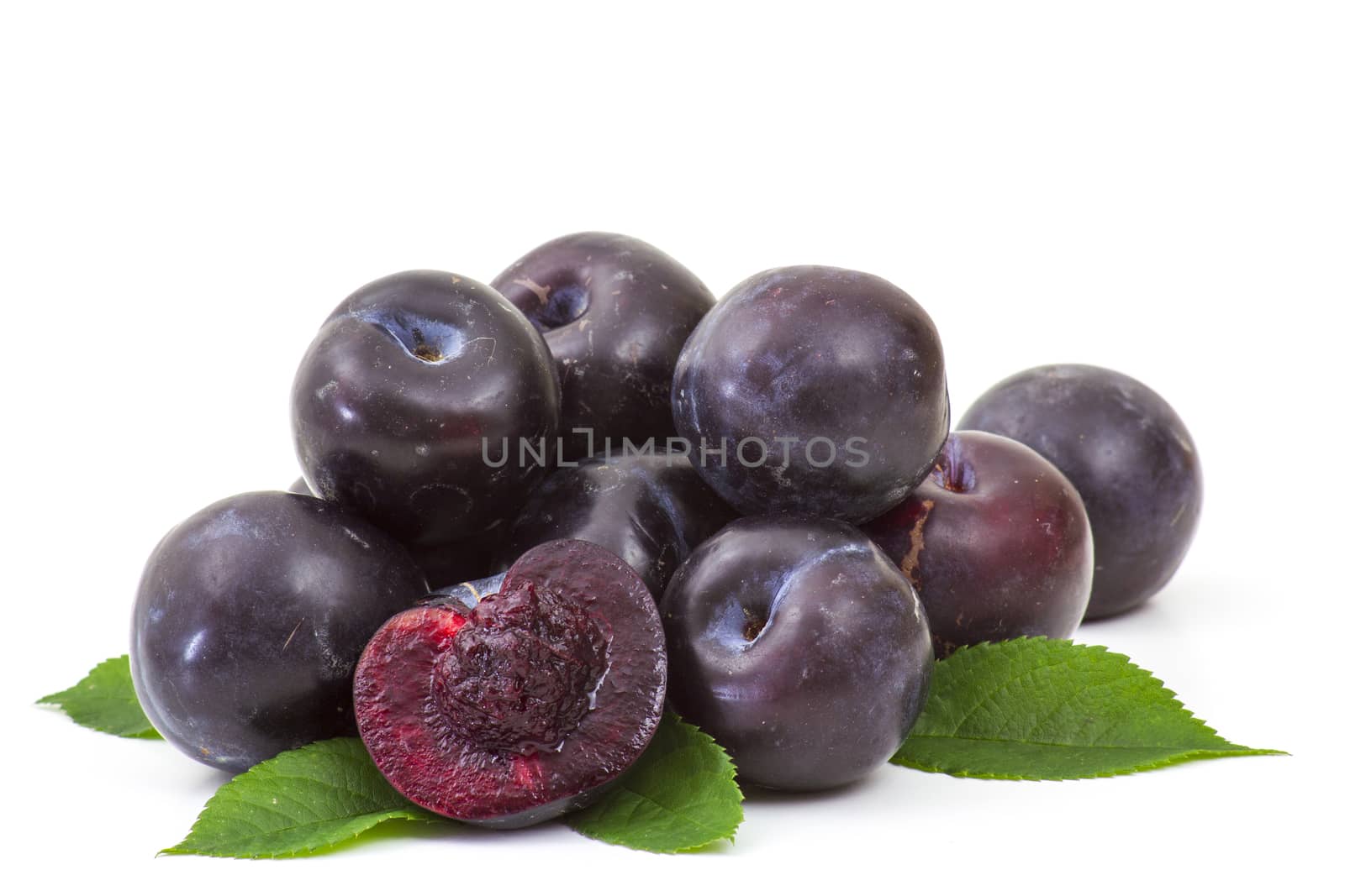 fresh plums on white background by miradrozdowski