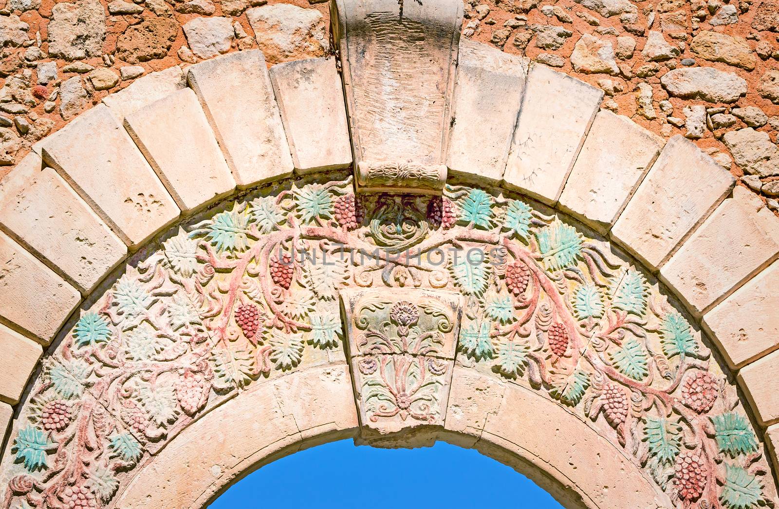 Fragment of the ancient gate decorated with the image of grapes, separating old part of the city of Retimno from the modern. Island of Crete, Greece.