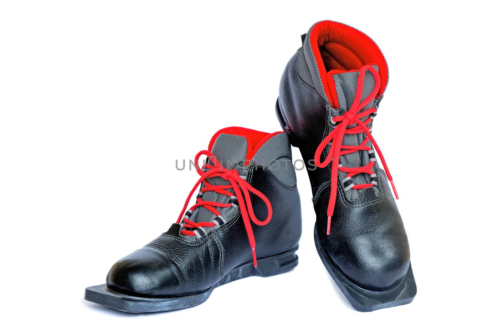 Black boots with red finishing for skiing. Are presented on a white background.