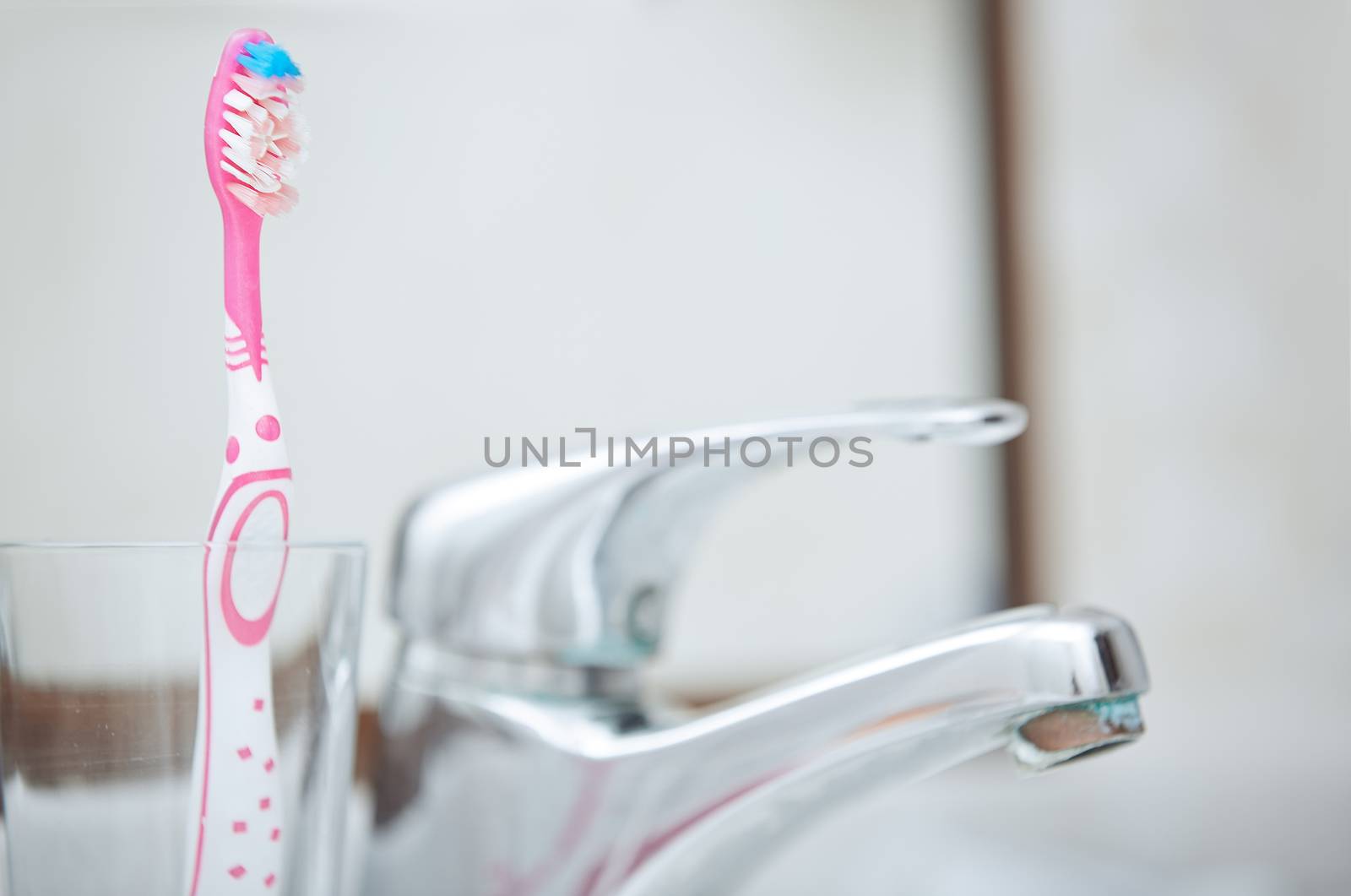 Toothbrush and water tap in domestic bathroom
