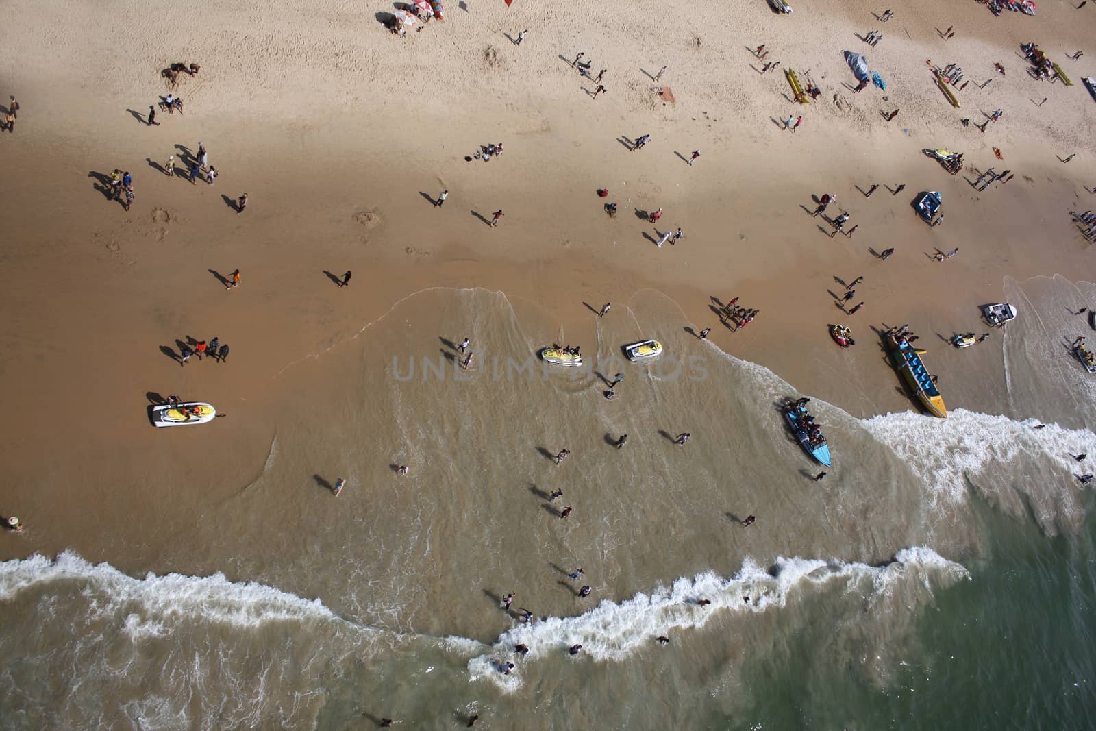A birdseye view of the tourists holidaying and having fun with beach sports in Goa
