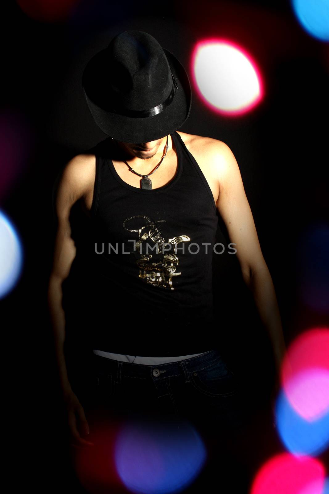 A Stylish Dancer in a spotlight and colorful lights