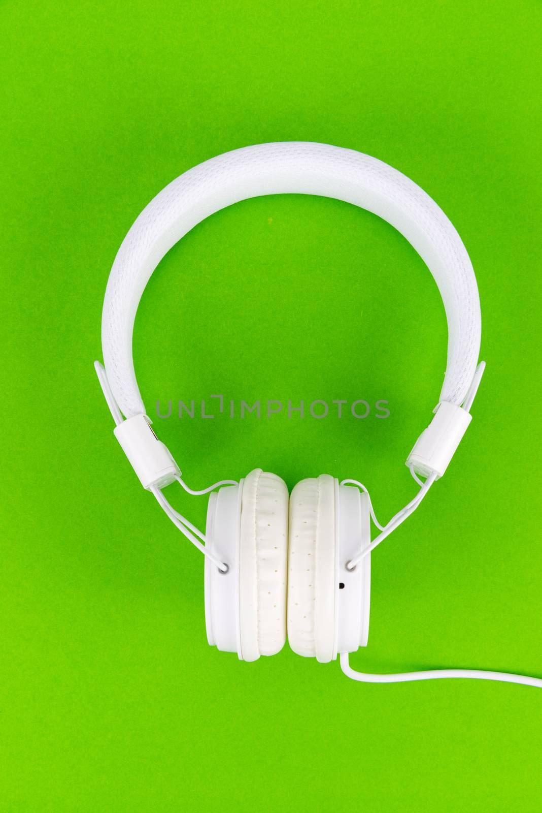 White headphone on green background