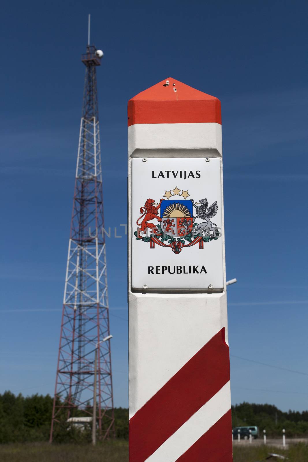 Latvia country border sign between Latvia and Lithuania with coat of arms and flag.