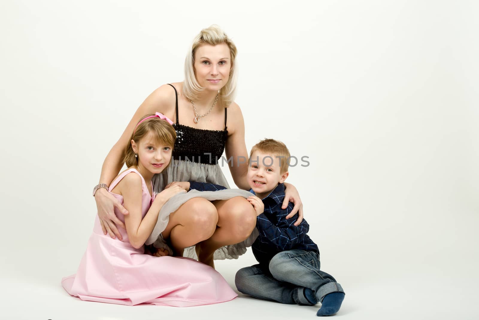 Studio portrait of siblings beautiful boy and girl and mother
