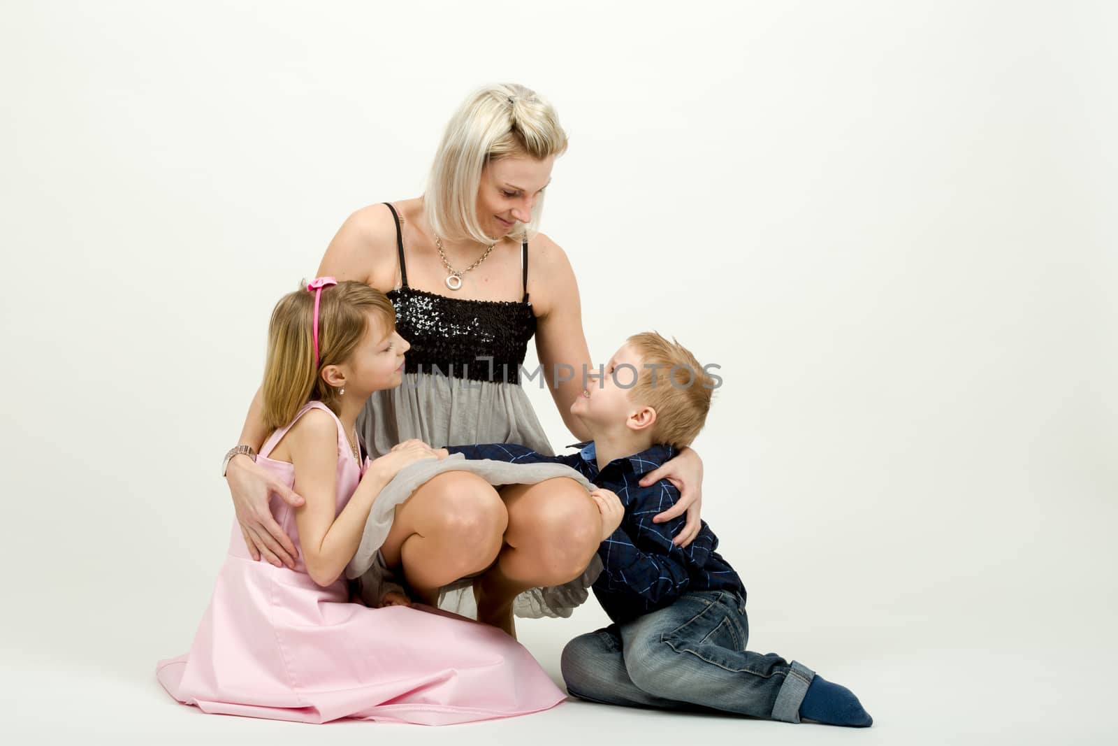 Studio portrait of siblings beautiful boy and girl and mother