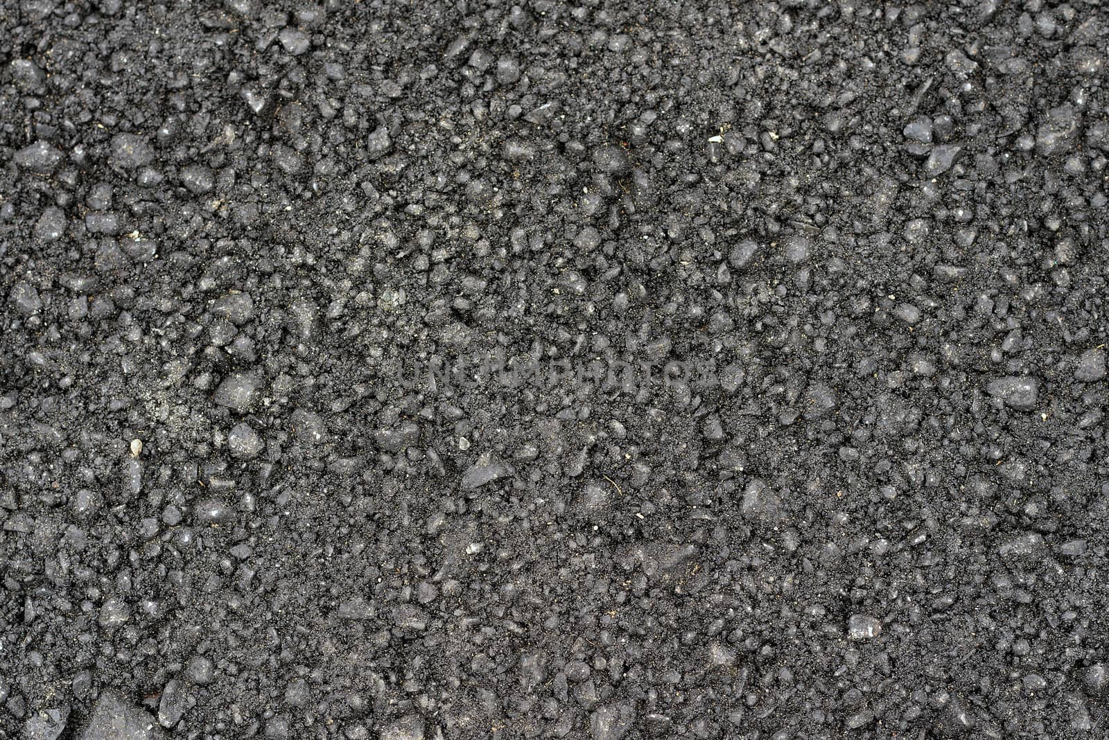 New black rough asphalt. The construction background