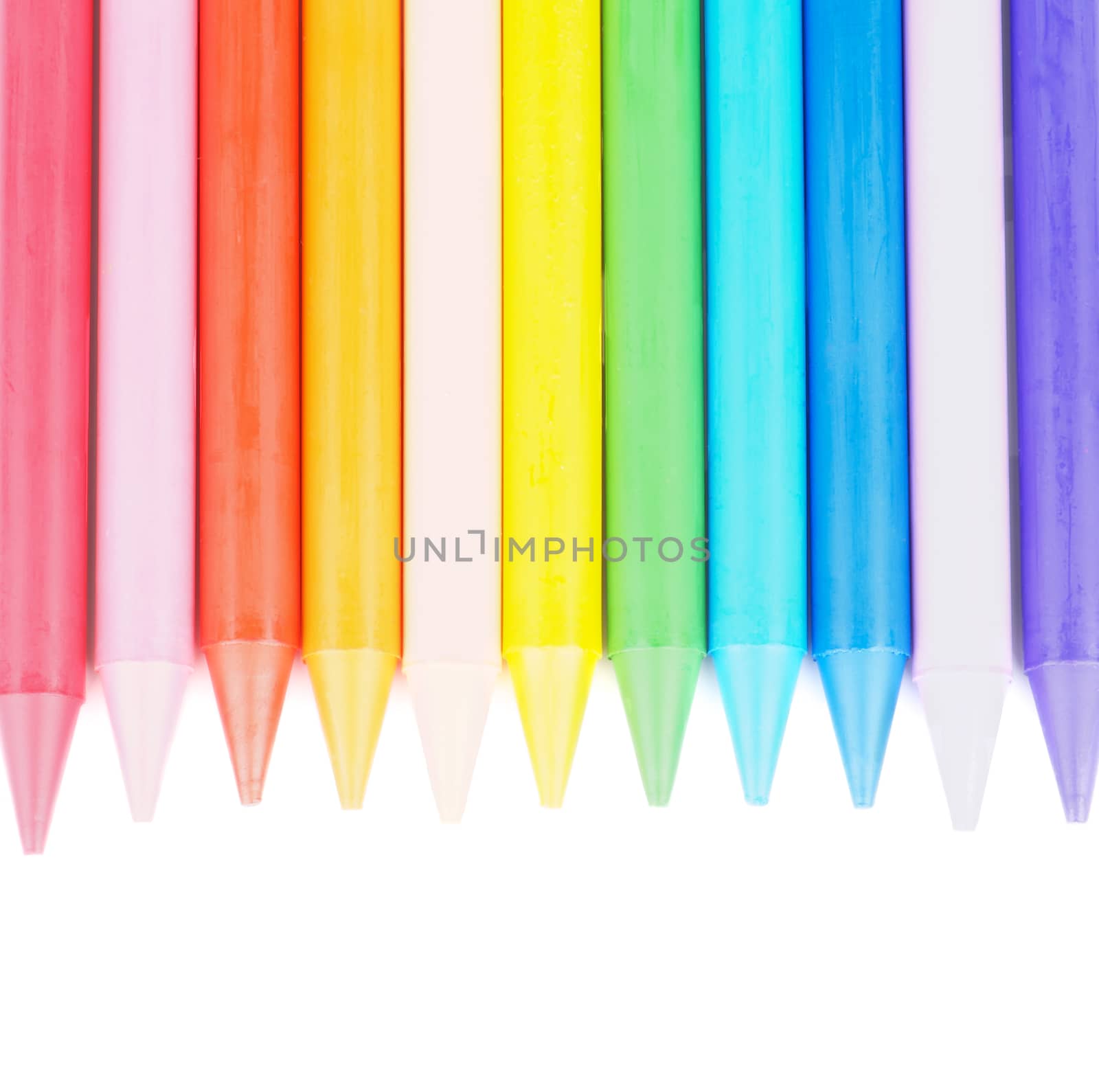 Border of Multicolored Polymeric Crayons isolated on white background. Top View