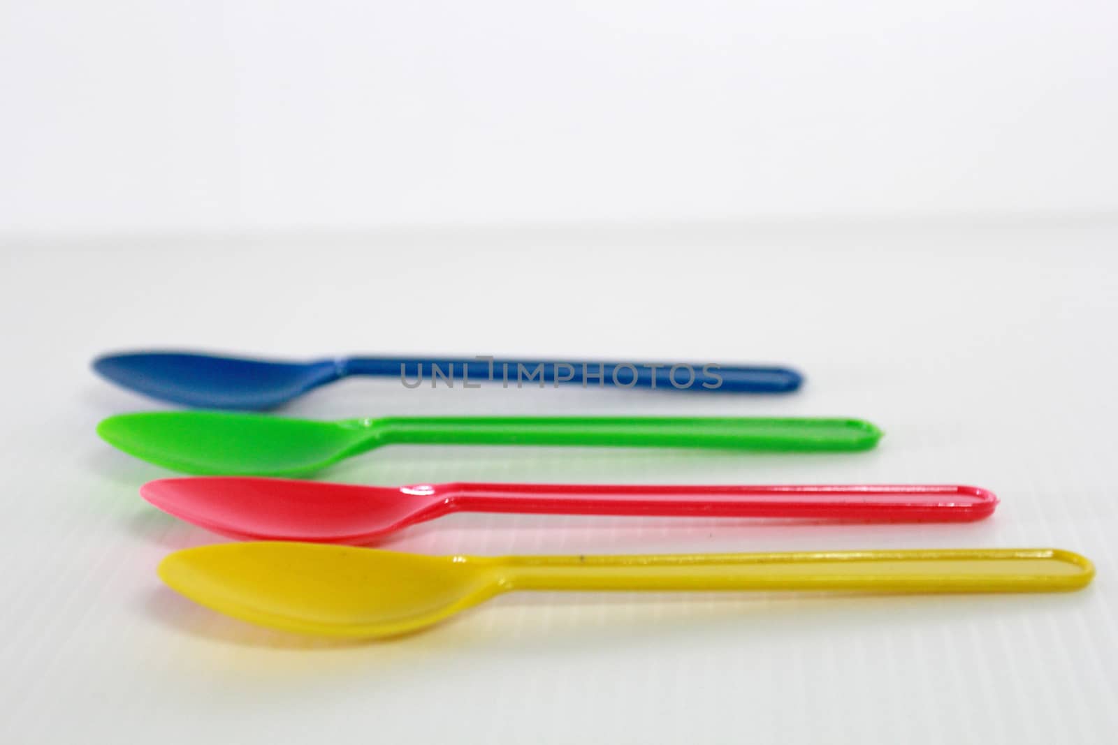 There are colour plastic spoons use for eating icecream and desert.