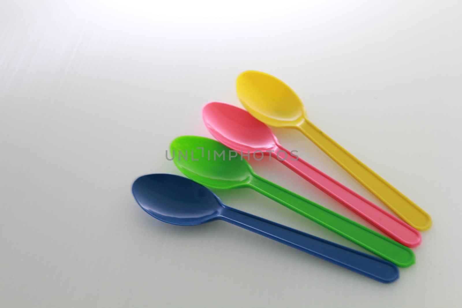 There are colour plastic spoons use for eating icecream and desert.