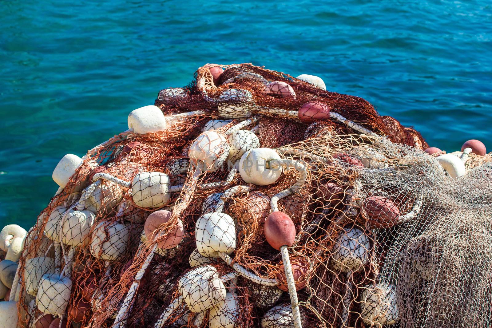 Fishing net pile by the blue sea