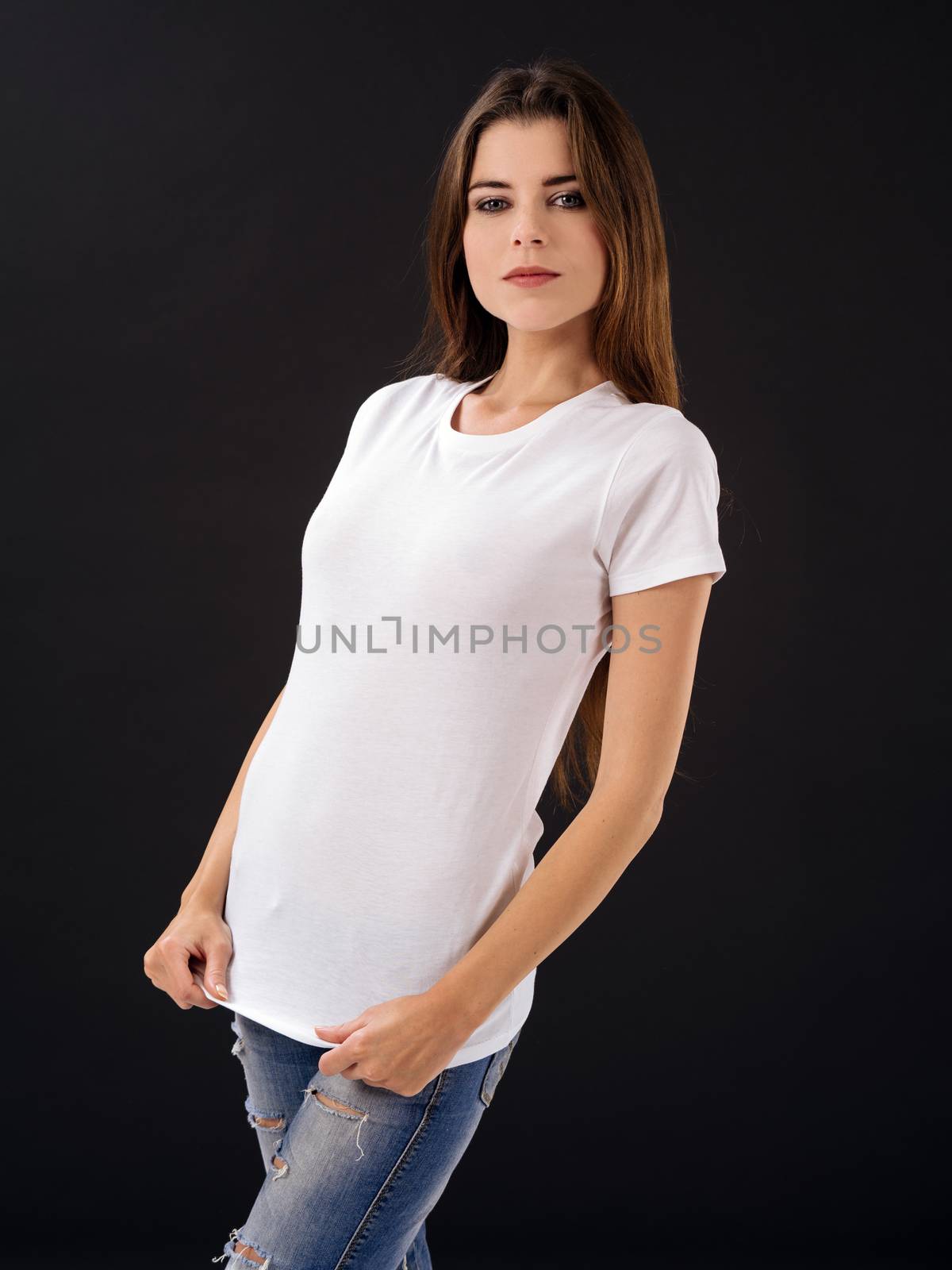 Woman with blank white shirt over black background by sumners