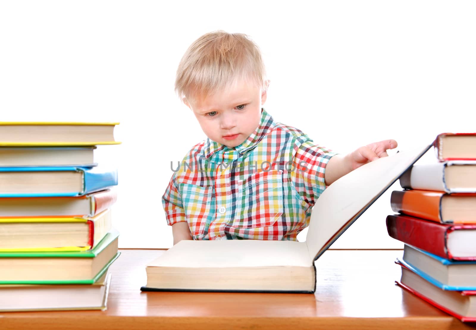 Baby Boy with the Books at the Desk Isolated on the White Background