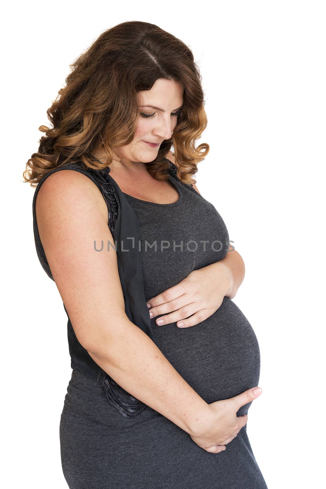 pregnant woman holding her hands on her belly 