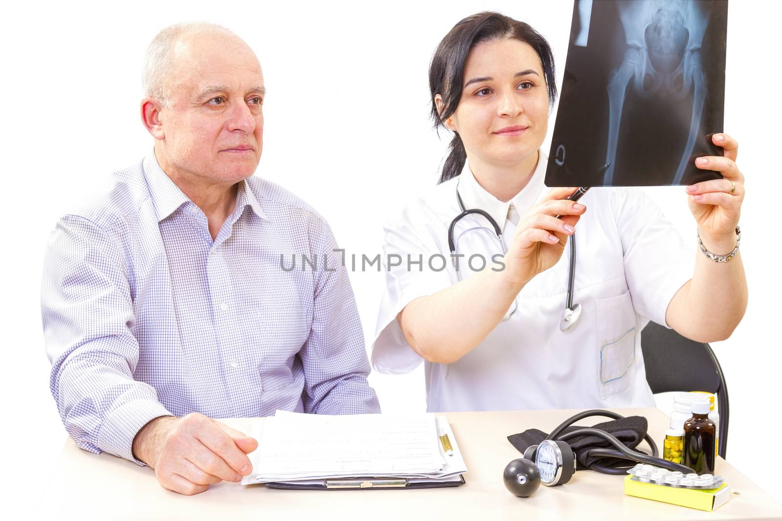 Women doctor showing a x-ray image to the patient.