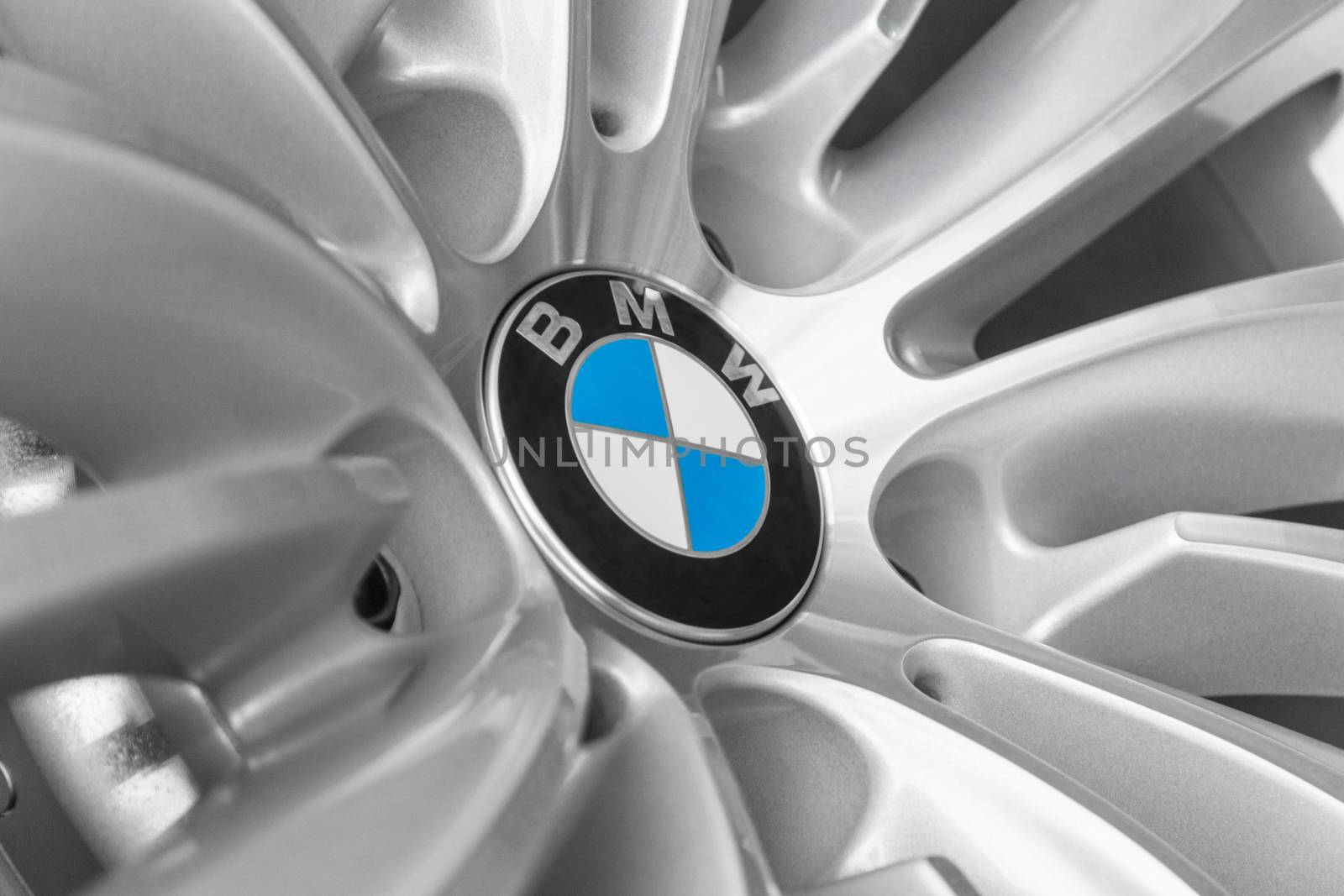 MUNICH, GERMANY - AUGUST 9, 2014: BMW European automobile manufacturer logotype on light alloy new design wheel for modern model of luxury business cars.
