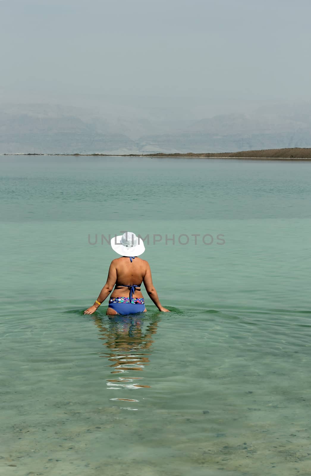 Woman in the water of the Dead sea Israel