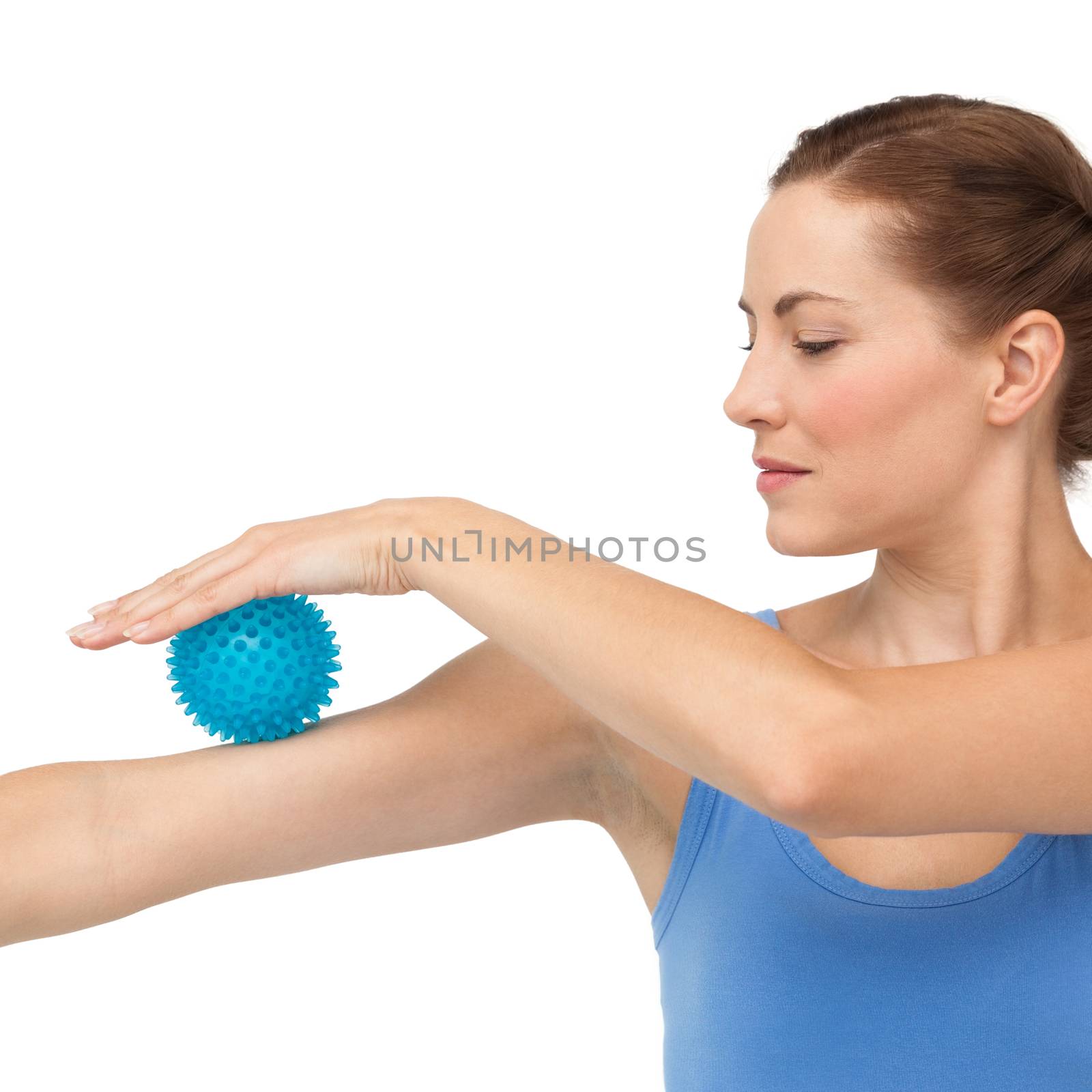 Portrait of a young woman holding stress ball on arm by Wavebreakmedia