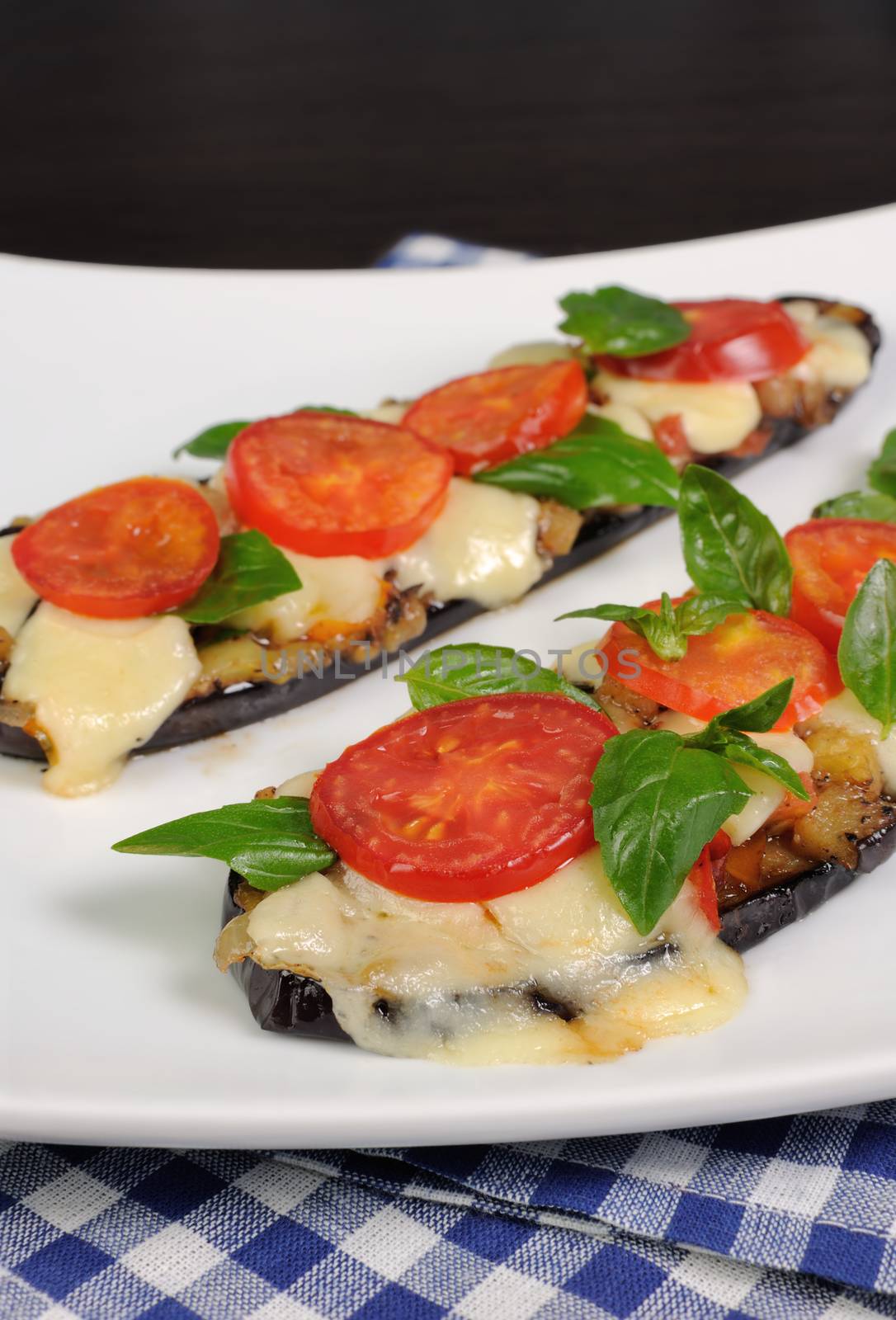 Sliced eggplant baked with tomato and basil and cheese