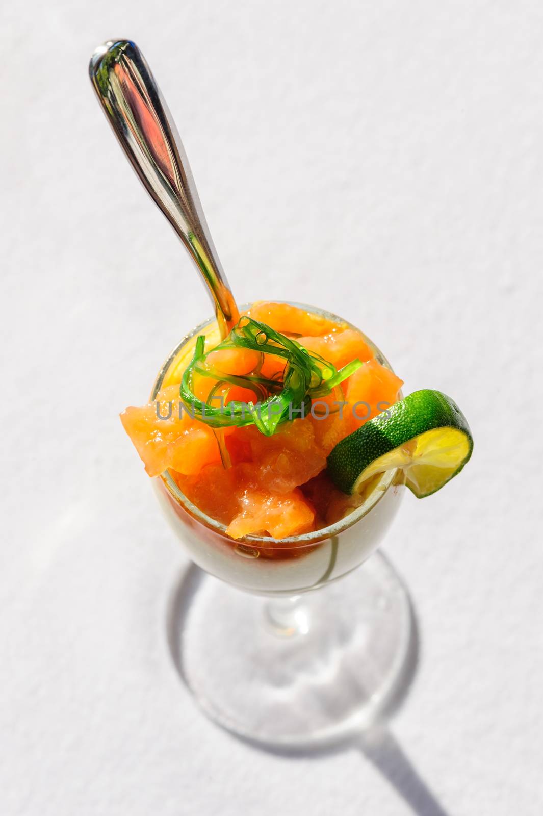 Closeup of a fresh salad with salted salmon and seaweed